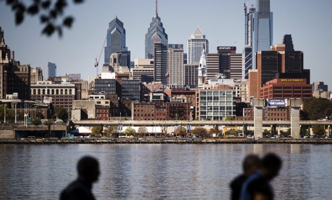 The Philadelphia skyline is seen along the banks of the Delaware River. 