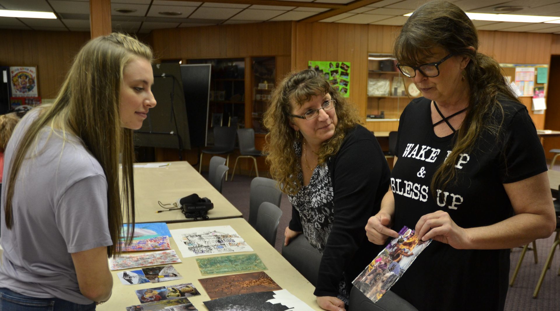 Mt. Aloysius College student Kylee Clawson, at left, and Pamela Townsend, center, look at art made by Jenny Behe, at right. Clawson, a surgical technology major, is participating in the art program as part of a college class. Townsend and Behe each have struggled with behavioral illnesses and work as peer support specialists.