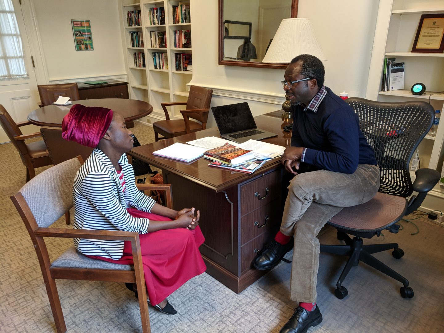Patience Bulus speaks with Professor Jacob Udo-Udo Jacob in his office at Dickinson College. 