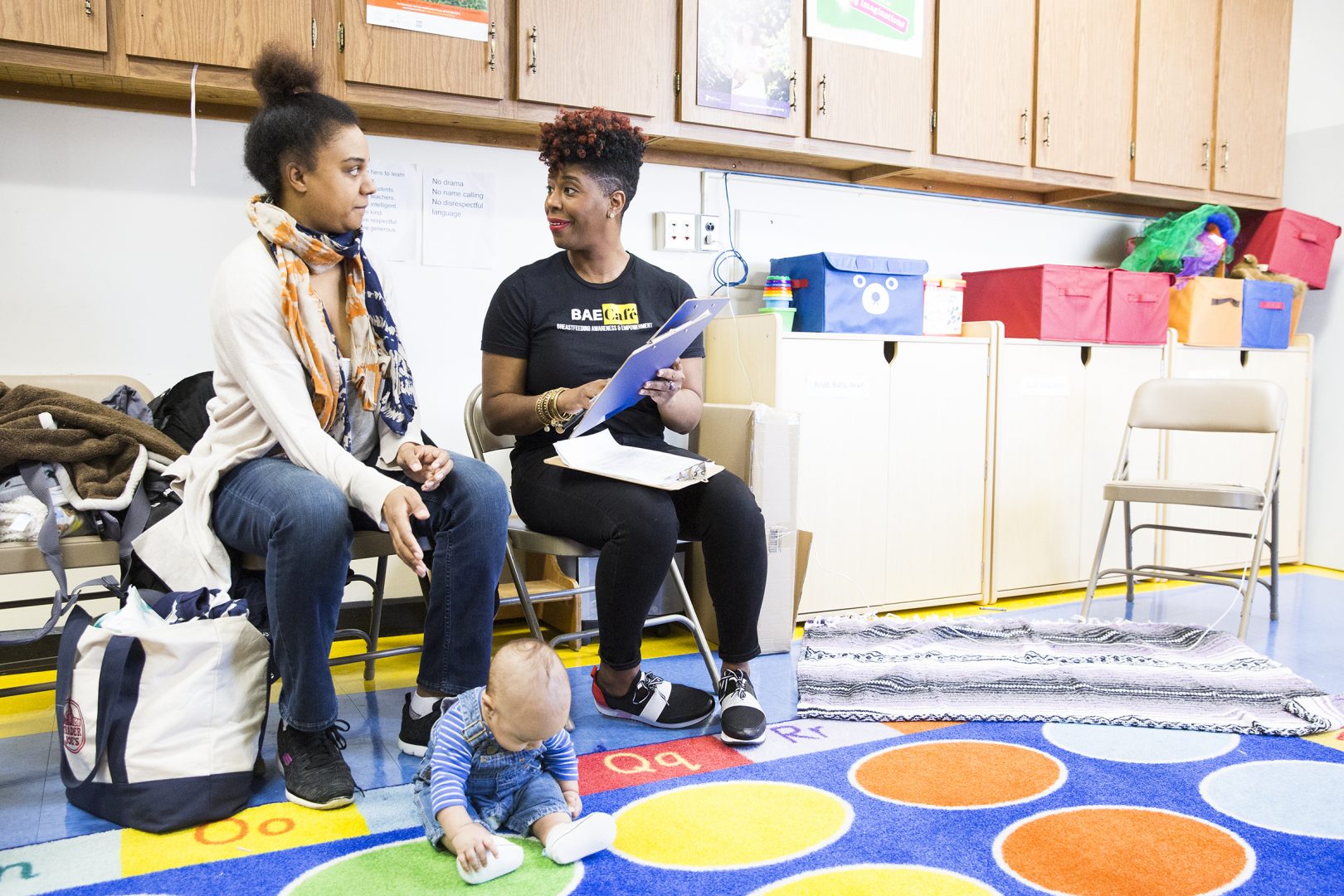 Jabina Coleman (right) introduces herself to Pamela Newman and 3-month-old James at the Lucien E. Blackwell library in Philadelphia. Coleman leads a breastfeeding class and co-runs the Prenatal Mental Health Alliance for Women of Color. In February, some mothers described experiencing postpartum depression.
