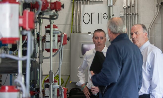 Rep. Brian Fitzpatrick, of Pennsylvania&rsquo;s 1st congressional district, (center) and Rep. Dan Kildee, from Michigan&rsquo;s 5th congressional district listen as Joseph J. Nolan, a county consulting engineer for Warminster Township in Pennsylvania, explains how the new water treatment system on Well 10 works to remove the PFAS contamination. 