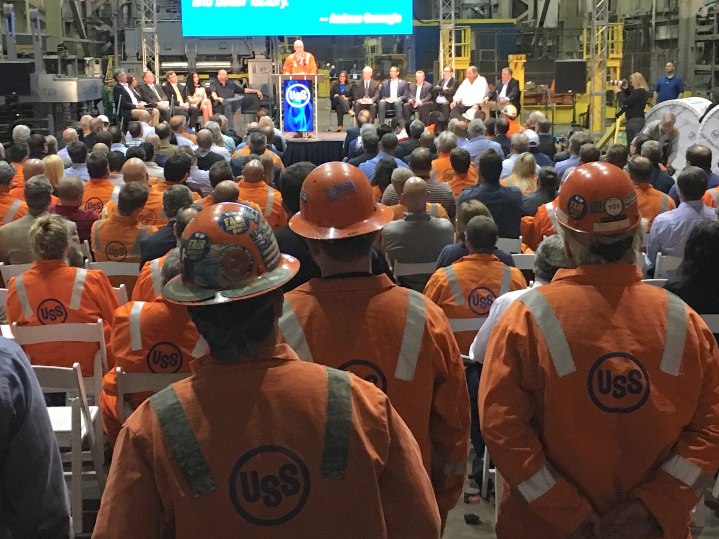 Steelworkers watch Thursday as U.S. Steel president and CEO David Burritt announces a $1-billion investment in upgrades at Clairton Coke Works and the Edgar Thomson plant near Pittsburgh.
