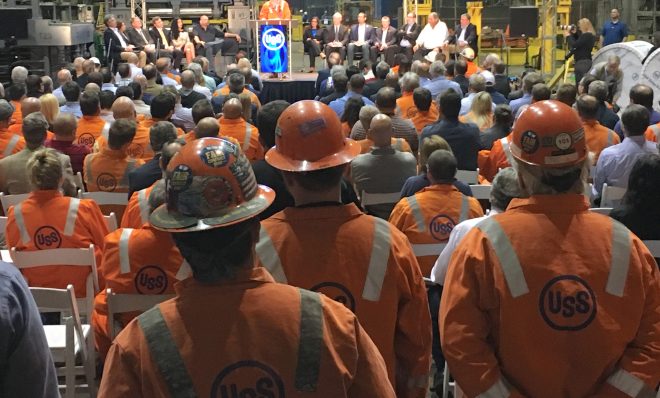 Steelworkers watch Thursday as U.S. Steel president and CEO David Burritt announces a $1-billion investment in upgrades at Clairton Coke Works and the Edgar Thomson plant near Pittsburgh.