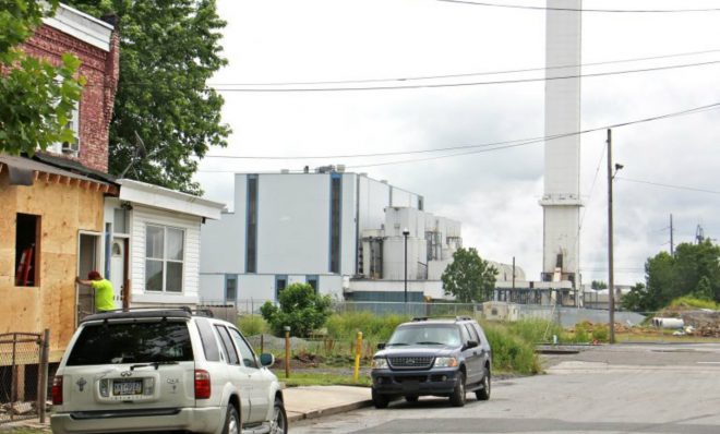 The smokestack of the Delaware Valley Resource Recovery Facility looms over a residential street in Chester.