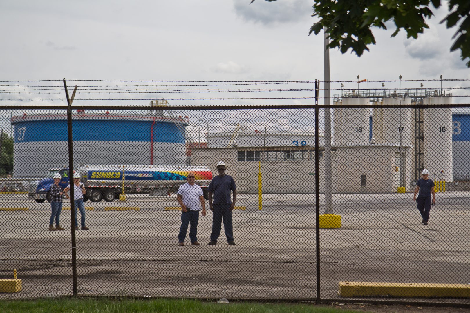 Refinery workers watch protestors outside the PES refinery Tuesday. 