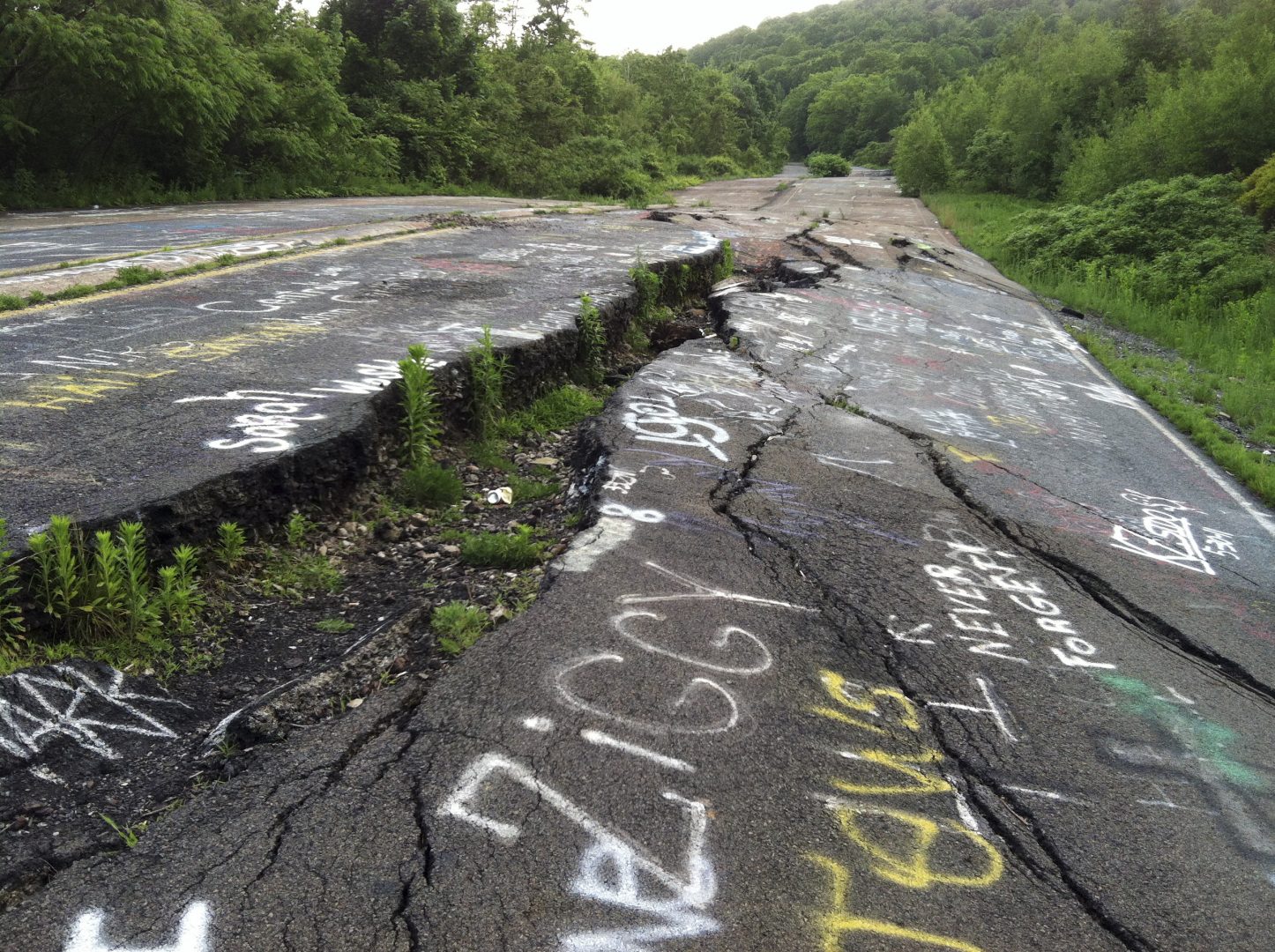In this May 24, 2012 photo, Route 61 is shown eroded and covered in graffiti in Centralia, Pa. Fifty years ago a fire at the town dump spread to a network of coal mines underneath hundreds of homes and business in the northeastern Pennsylvania borough of Centralia, eventually forcing the demolition of nearly every building. 