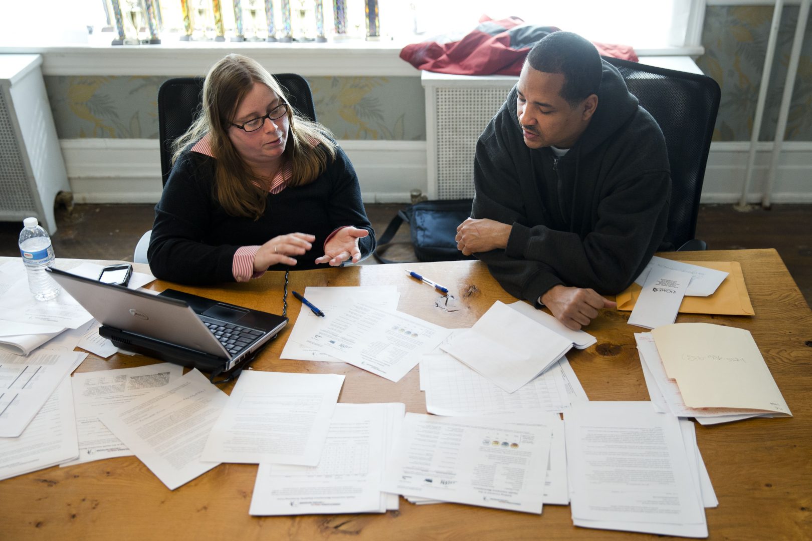 Erik Furness meets with Antoinette Kraus with the Pennsylvania Health Access Network to begin the process of signing up for insurance under the Affordable Care Act, Monday, March 31, 2014, at Project HOME's St. Elizabeths Community and Wellness Center in Philadelphia. 