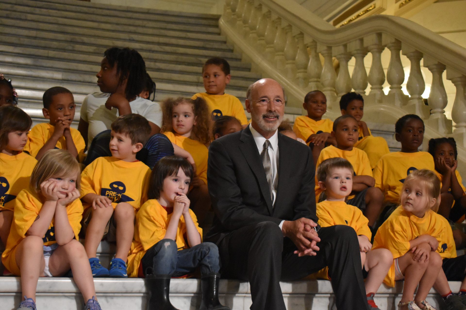 Gov. Tom Wolf sits on the steps of the Capitol rotunda on June 28, 2019, ahead of a news conference to celebrate increased funding for education funding.