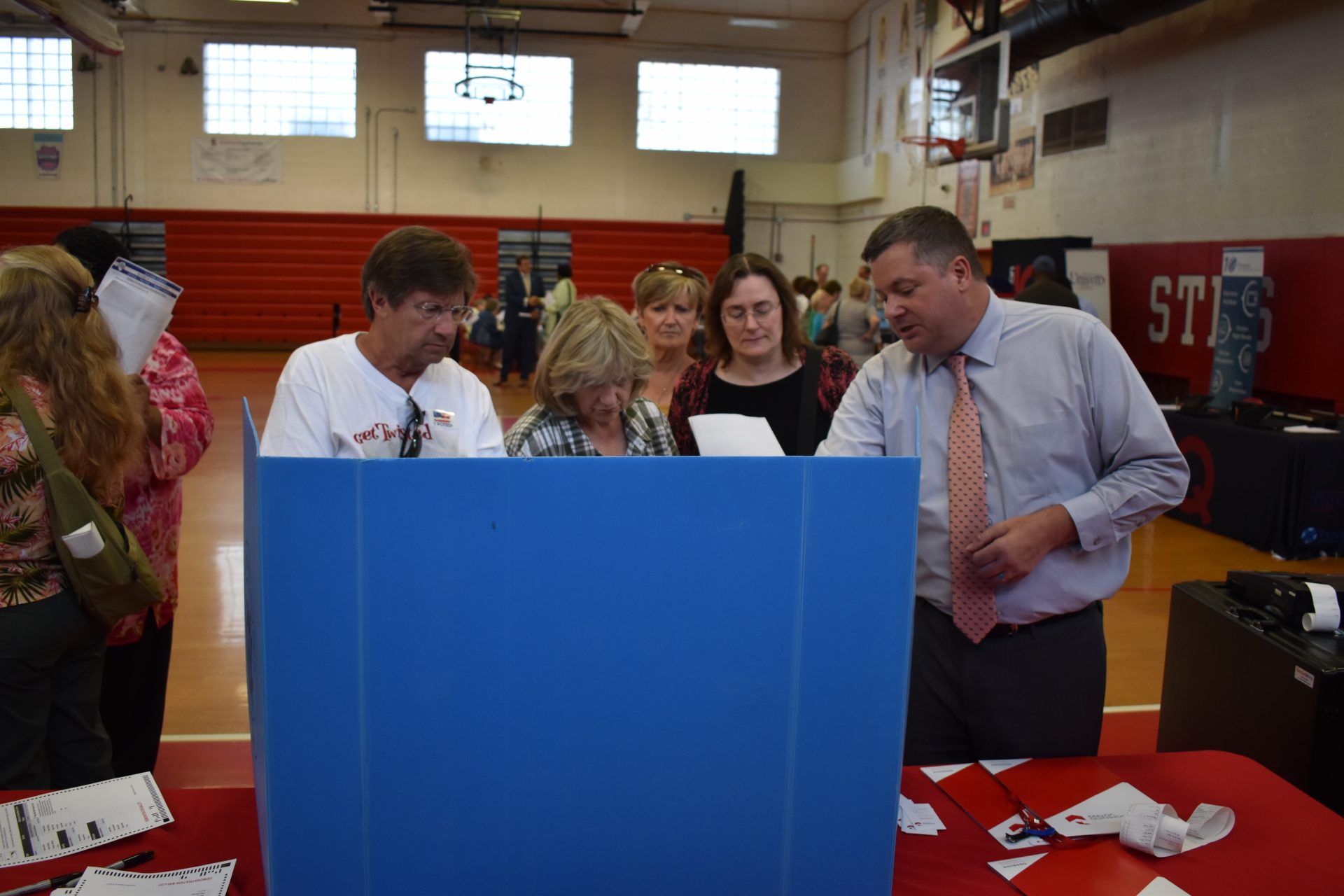 People look at one of the options for a new voting system during a demonstration at Susquehanna Township High School on June 11, 2019.
