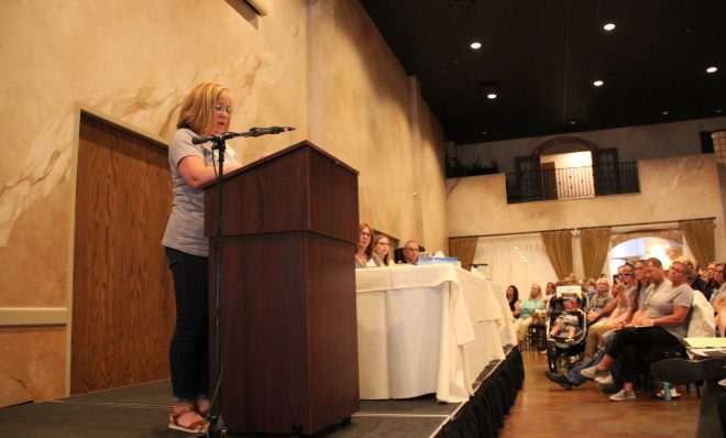 In this photo from June 2019, Janice Blanock speaks to a crowd at a meeting about cancer cases in Canonsburg, Pa. Her son Luke died of Ewing sarcoma in 2016. 
