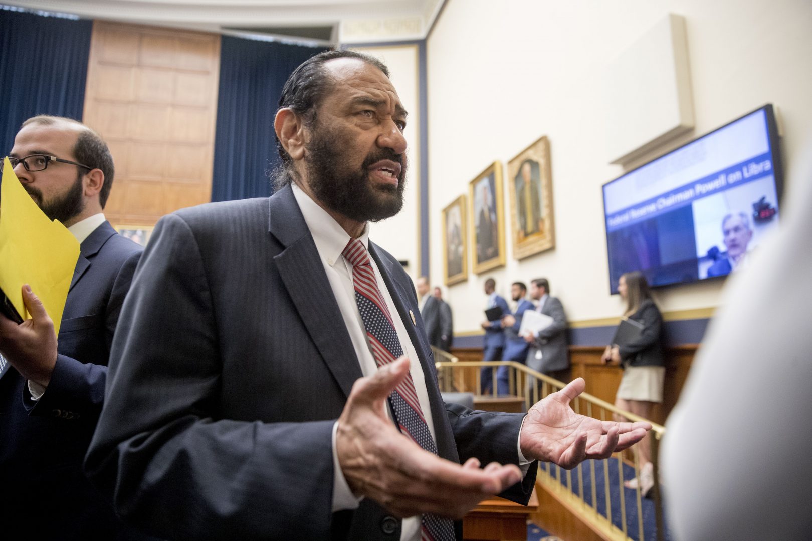 Rep. Al Green, D-Texas, right, speaks to visitors during a break from testimony from David Marcus, CEO of Facebook's Calibra digital wallet service, before a House Financial Services Committee hearing on Facebook's proposed cryptocurrency on Capitol Hill in Washington, Wednesday, July 17, 2019. Green has introduced a resolution in the House to impeach President Donald Trump.