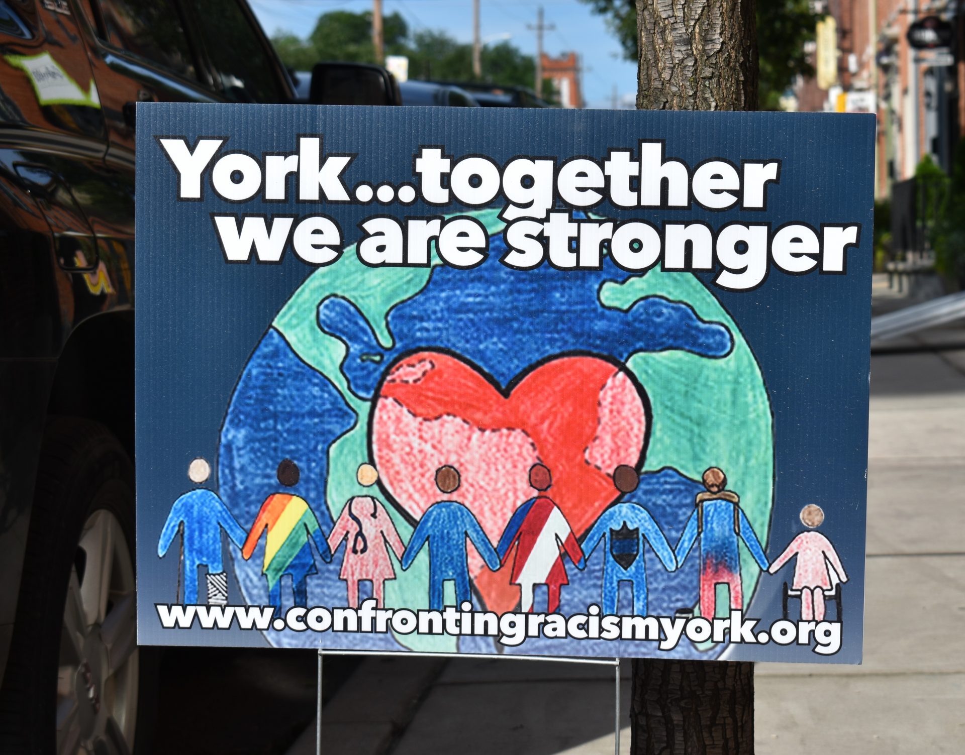 A sign for the Confronting Racism Coalition is seen in York on June 12, 2019.