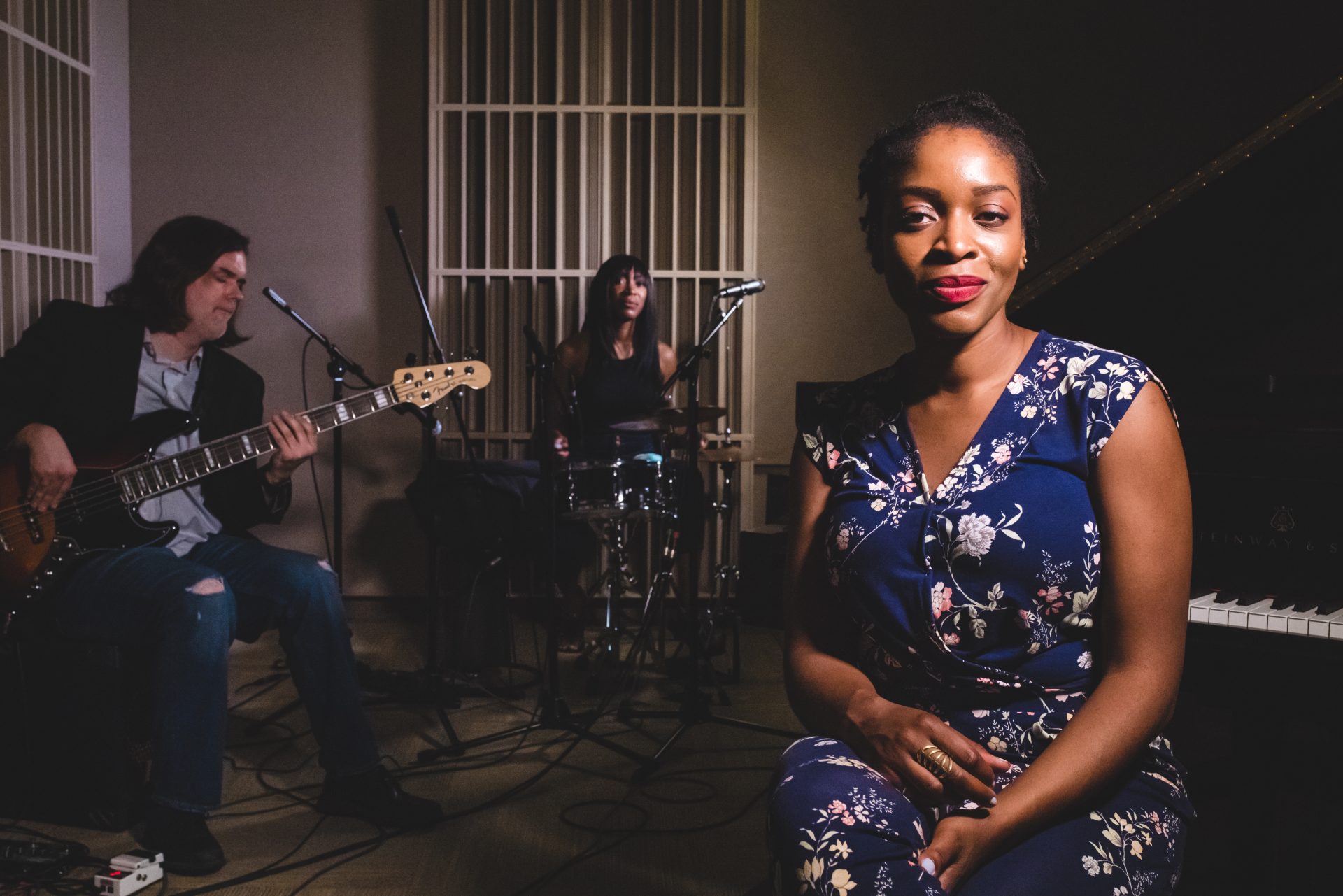 Joy Ike sitting with her band.