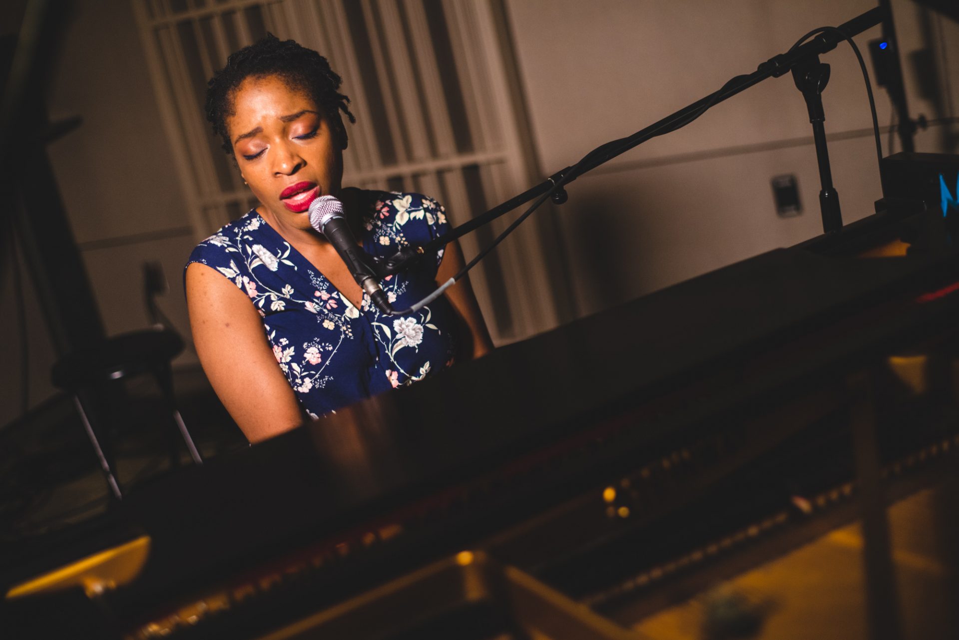 Joy Ike playing piano and singing