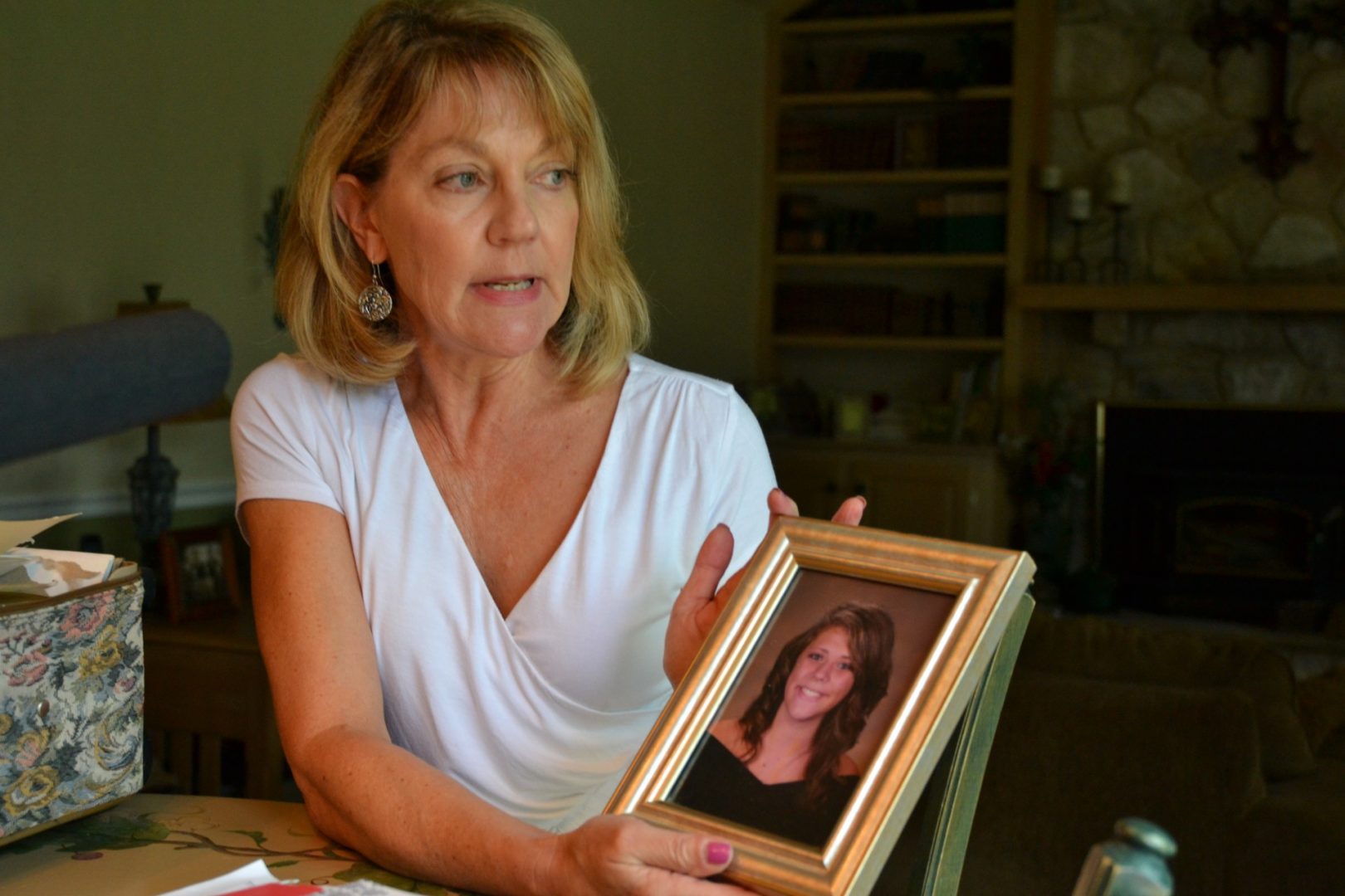 Martha Stringer holds a photo of her daughter, Kim, from when she was in high school. Kim is 27 now. 