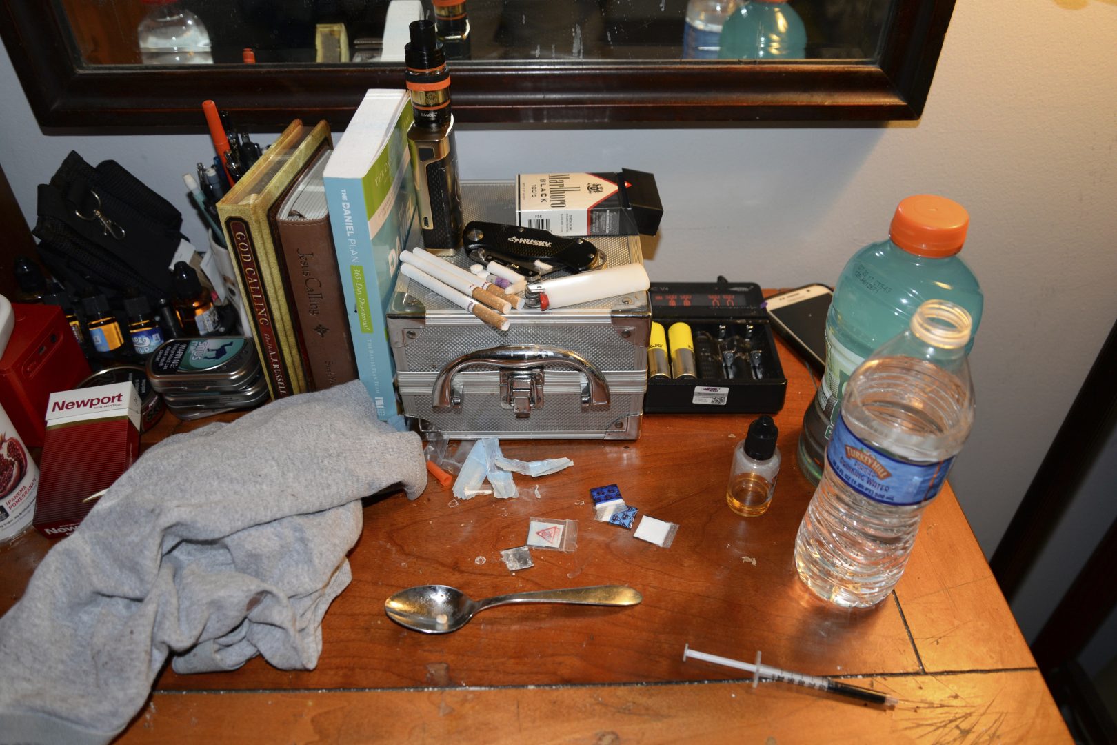 This Sunday, May 21, 2017, photo provided by the Chester County District Attorney's Office in West Chester, Pa., shows opioid drug packets, a syringe and other belongings found by law enforcement personnel in an addiction counselor's bedroom at the Freedom Ridge Recovery Lodge, a suburban Philadelphia halfway house in West Brandywine Township. 