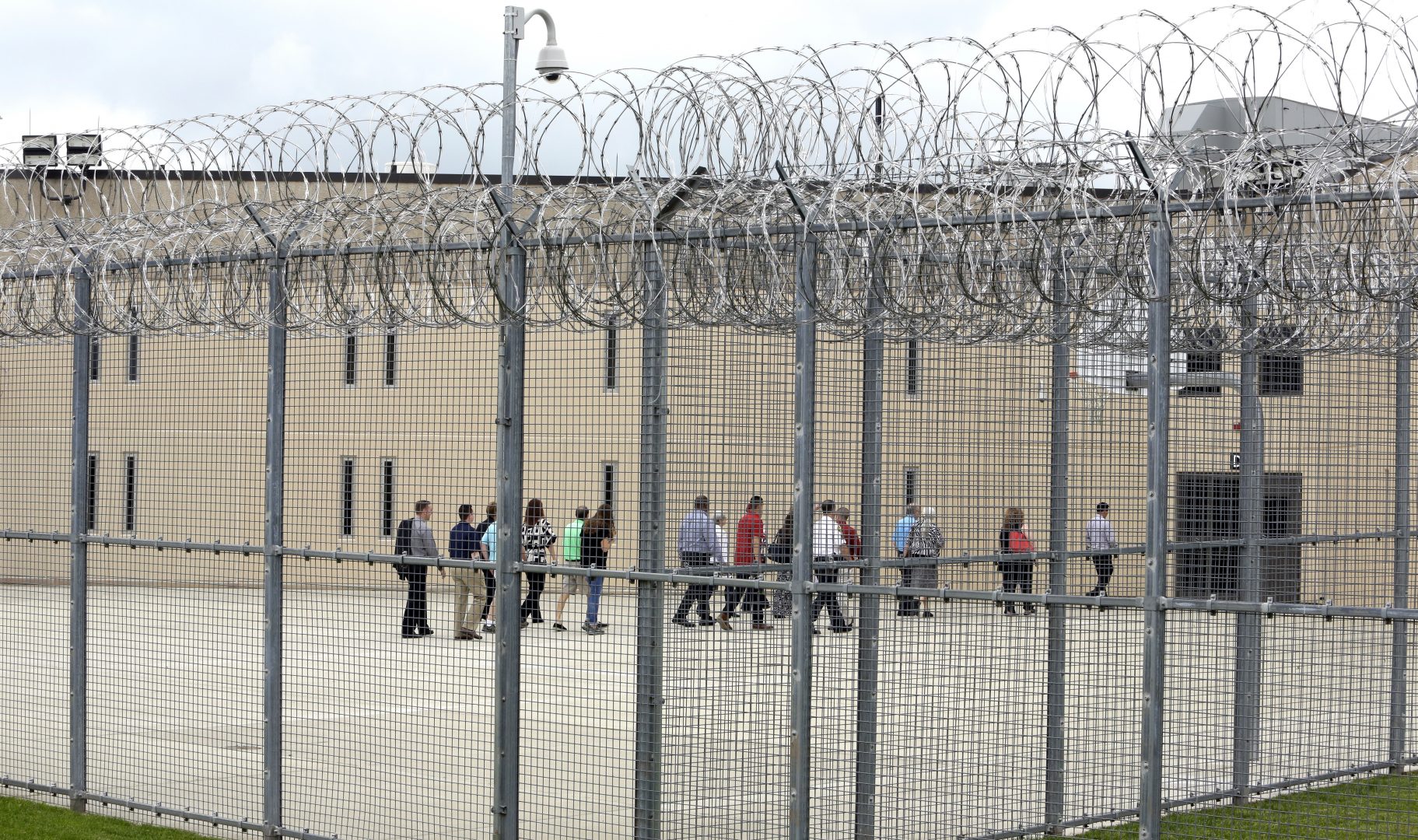 In this June 1, 2018, file photo, people walk on a tour of the West section of the State Correctional Institution at Phoenix in Collegeville, Pa. 