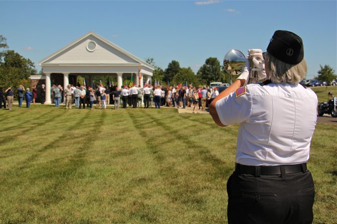 A bugler plays taps to end the funeral ceremony for 14 veterans who died unattended. The service took place at Washington Crossing National Cemetery in Newtown, Pa.