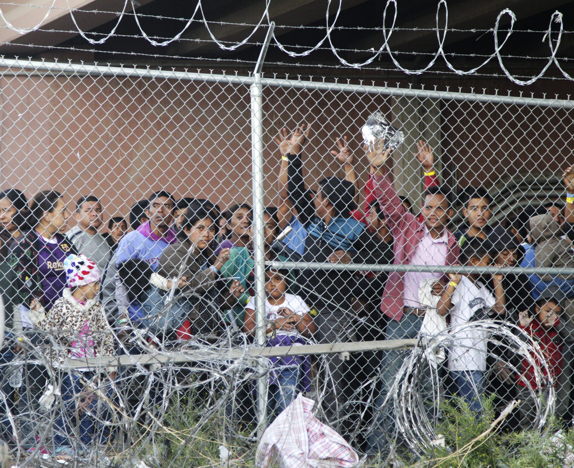 n this March 27, 2019, file photo, Central American migrants wait for food in a pen erected by U.S. Customs and Border Protection to process a surge of migrant families and unaccompanied minors in El Paso, Texas. Texas Gov. Greg Abbott says he's sending another 1,000 National Guard troops to the U.S.-Mexico border and blasted Congress as a "group of reprobates" over the growing humanitarian crisis. Abbott said Friday, June 21, 2019, that the additional Guard members will assist at detention facilities and at ports of entry.