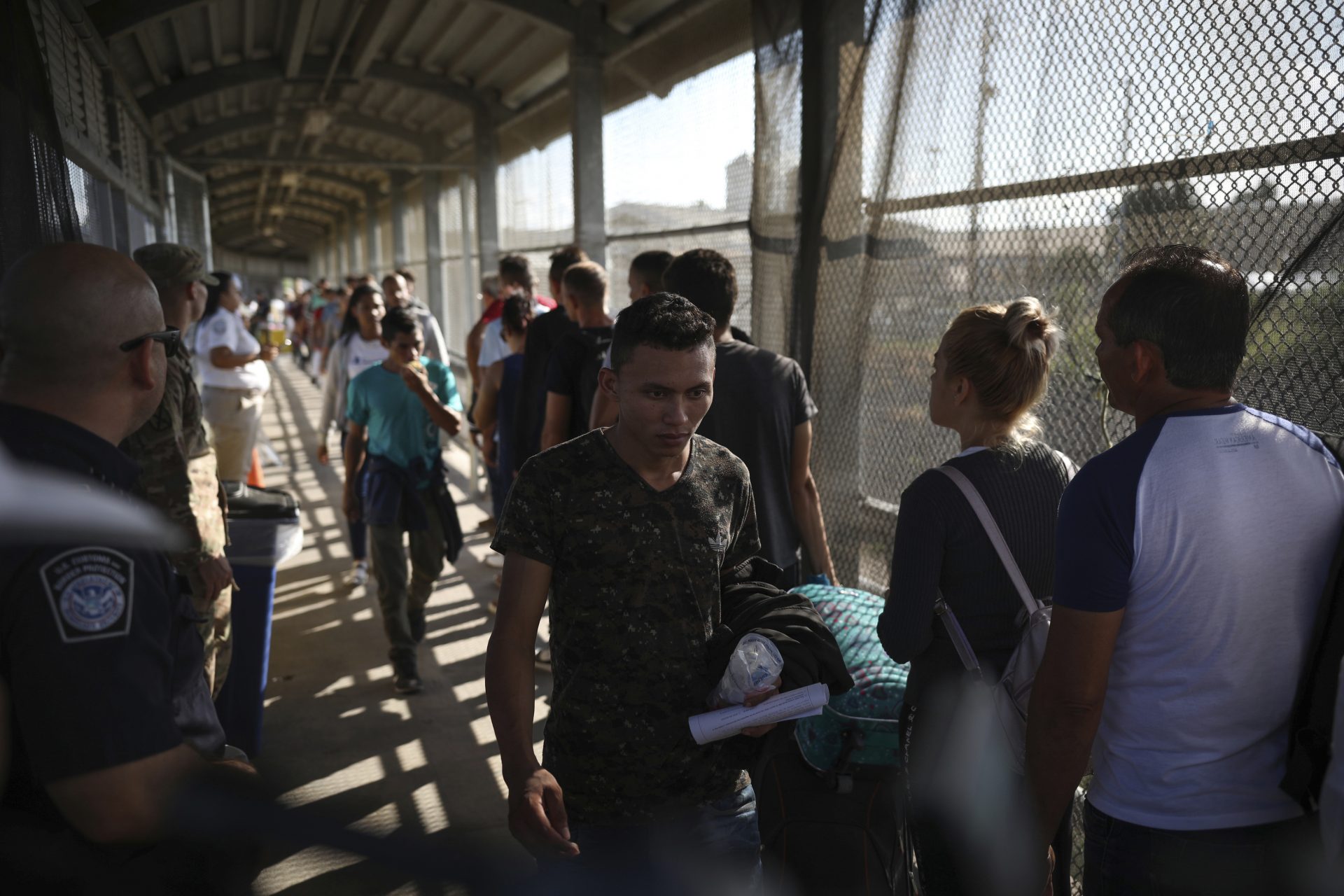 Migrants return to Mexico as 15 other migrants line up on their way to request asylum in the U.S., at the foot of the Puerta Mexico bridge that crosses into Brownsville, Texas, in Matamoros, Mexico, Friday, Aug. 2, 2019.