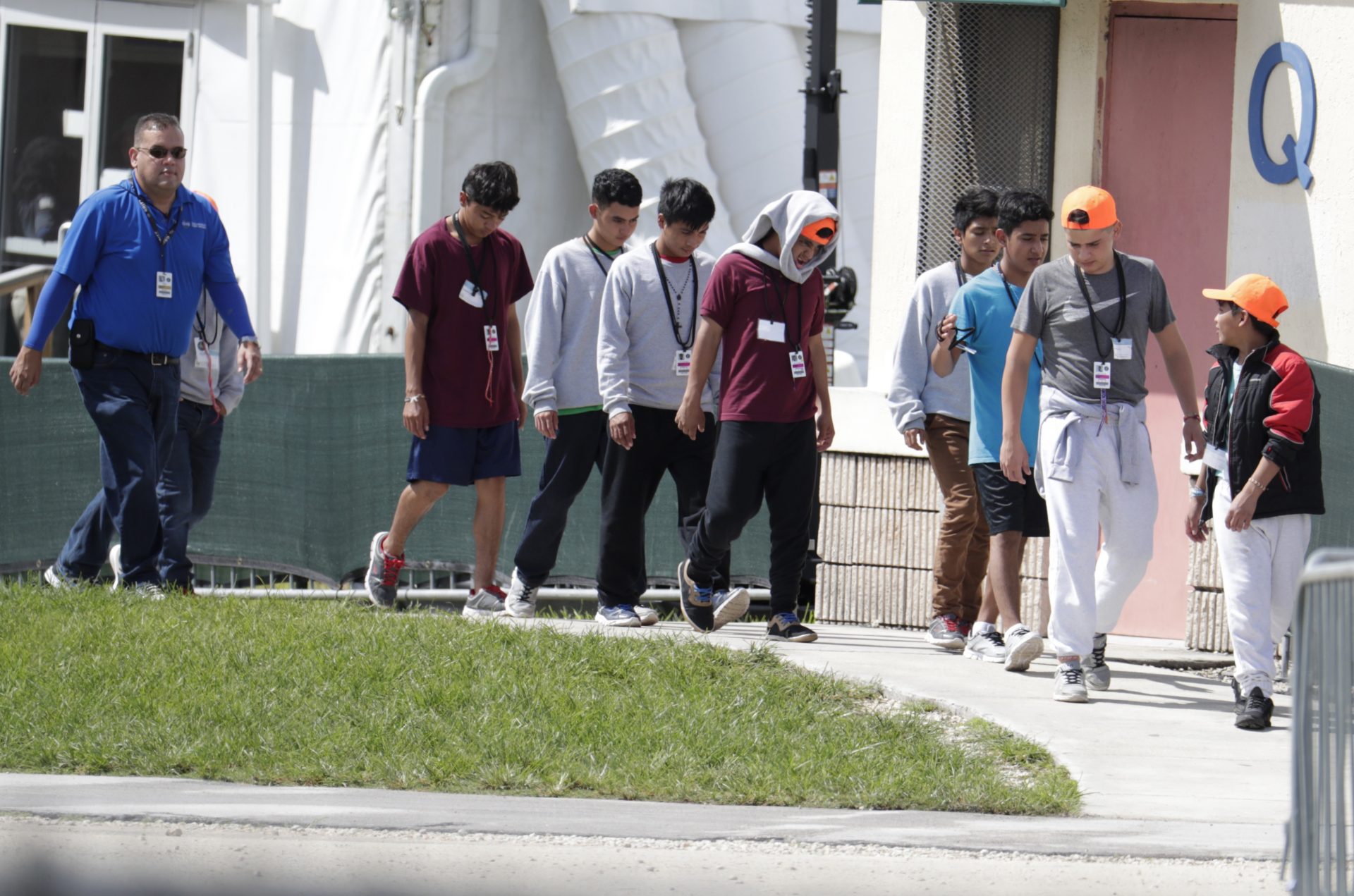 Migrant children walk on the grounds of the Homestead Temporary Shelter for Unaccompanied Children, Monday, July 15, 2019, in Homestead, Fla.