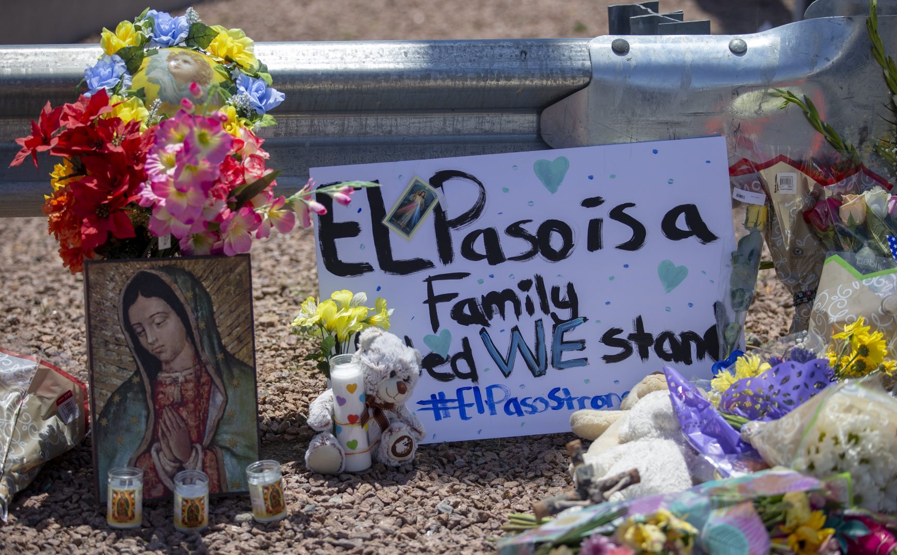 Flowers and a Virgin Mary painting adorn makeshift memorial for the victims of Saturday mass shooting at a shopping complex in El Paso, Texas, Sunday, August 4, 2019. 