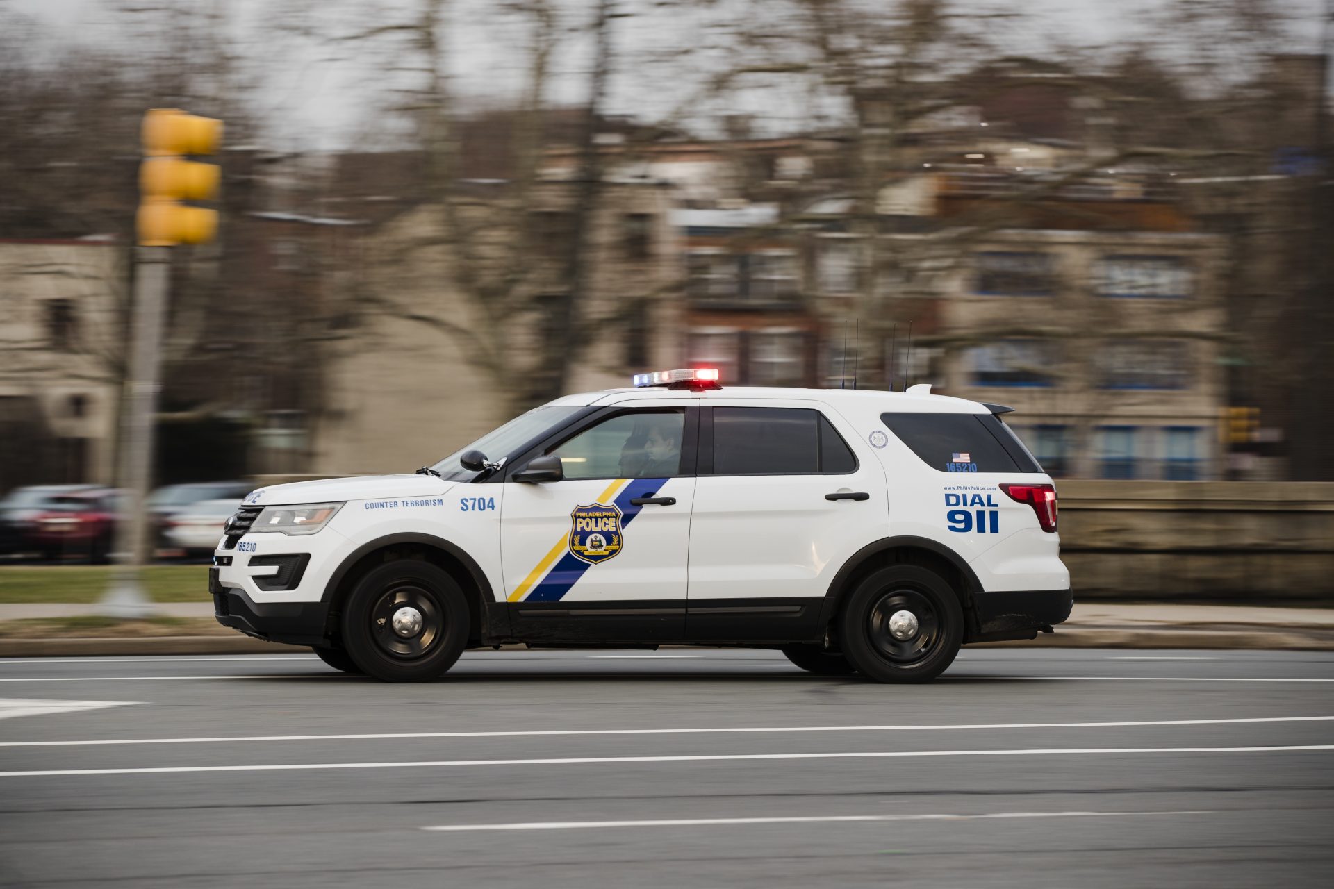 A police SUV drives with its lights flashing in Philadelphia, Tuesday, Jan. 8, 2019.