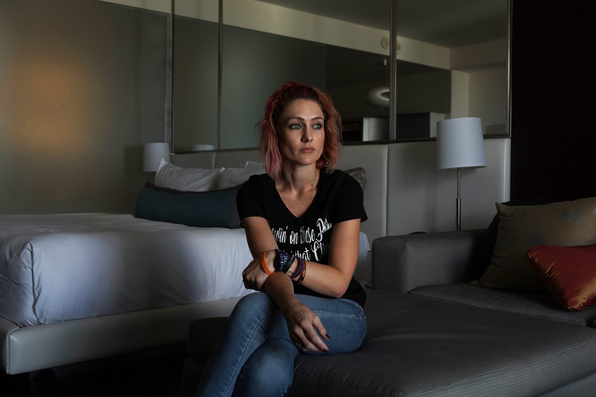 Survivor Brittany Bassett-Quintero sits in her hotel room overlooking the Las Vegas Strip on Sept. 30, 2018. Her shrapnel wounds have healed, but the emotional trauma has created aftershocks that seep into most corners of her life.