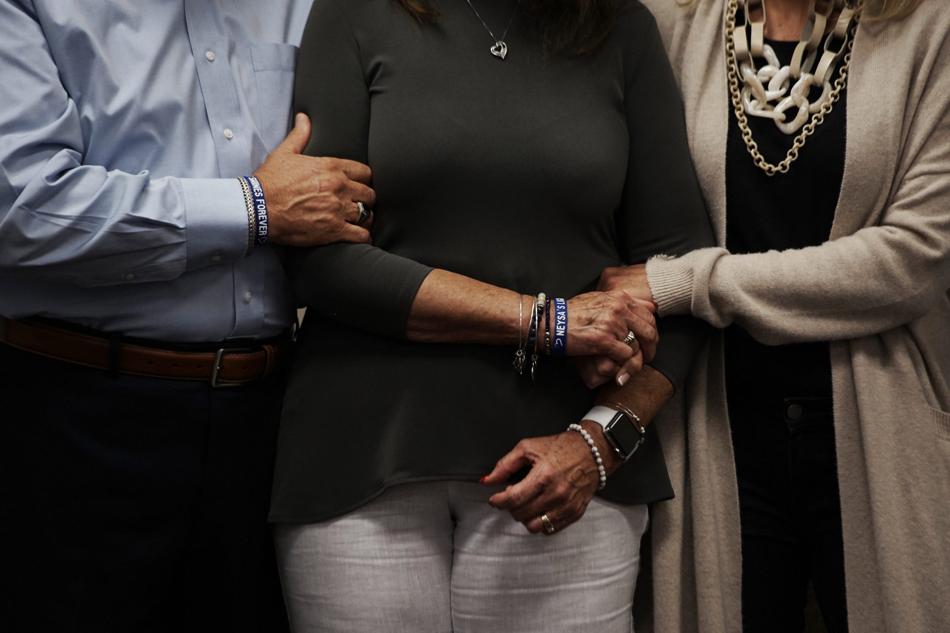 Neysa Tonks' parents, Chris and Debbie Davis, and sister, Mynda Smith, embrace during a news conference for Children of the 58 on Sept. 14, 2018, at the College of Southern Nevada in Las Vegas. Tonks was a single mother of three sons.