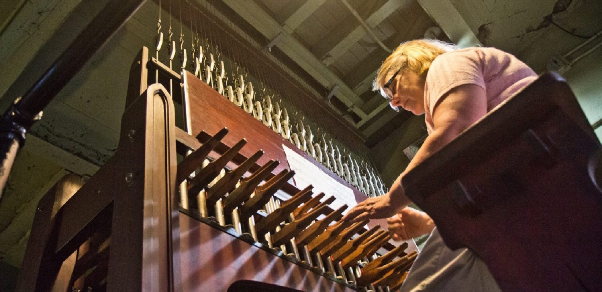 Janet Tebbel plays the carillon beneath the attached bells at the Miraculous Medal Shrine.