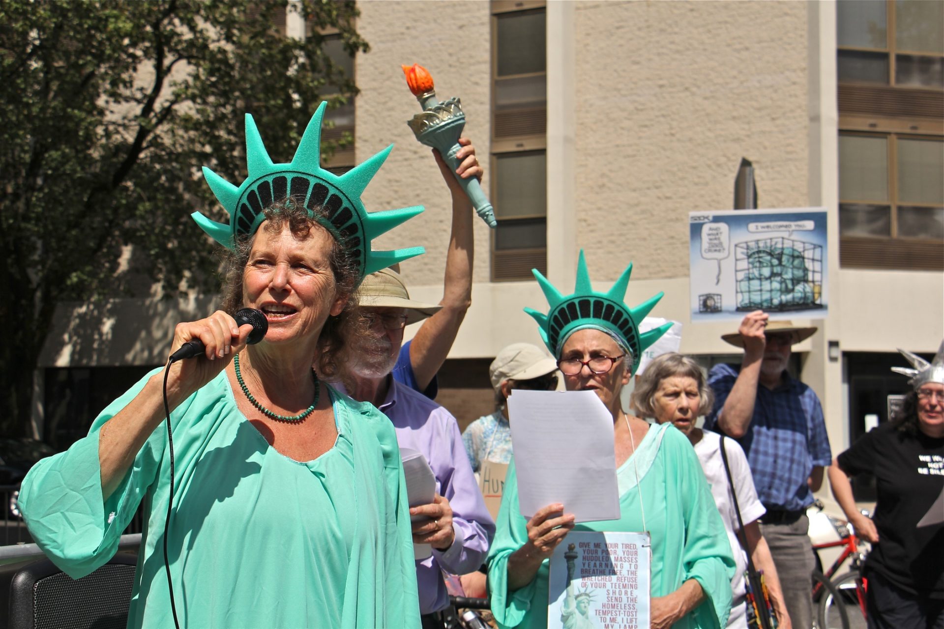 Lynne Iser of ElderWitness speaks outside the Philadelphia immigration enforcement field office during a protest against policies that separate families and put children in detention. 