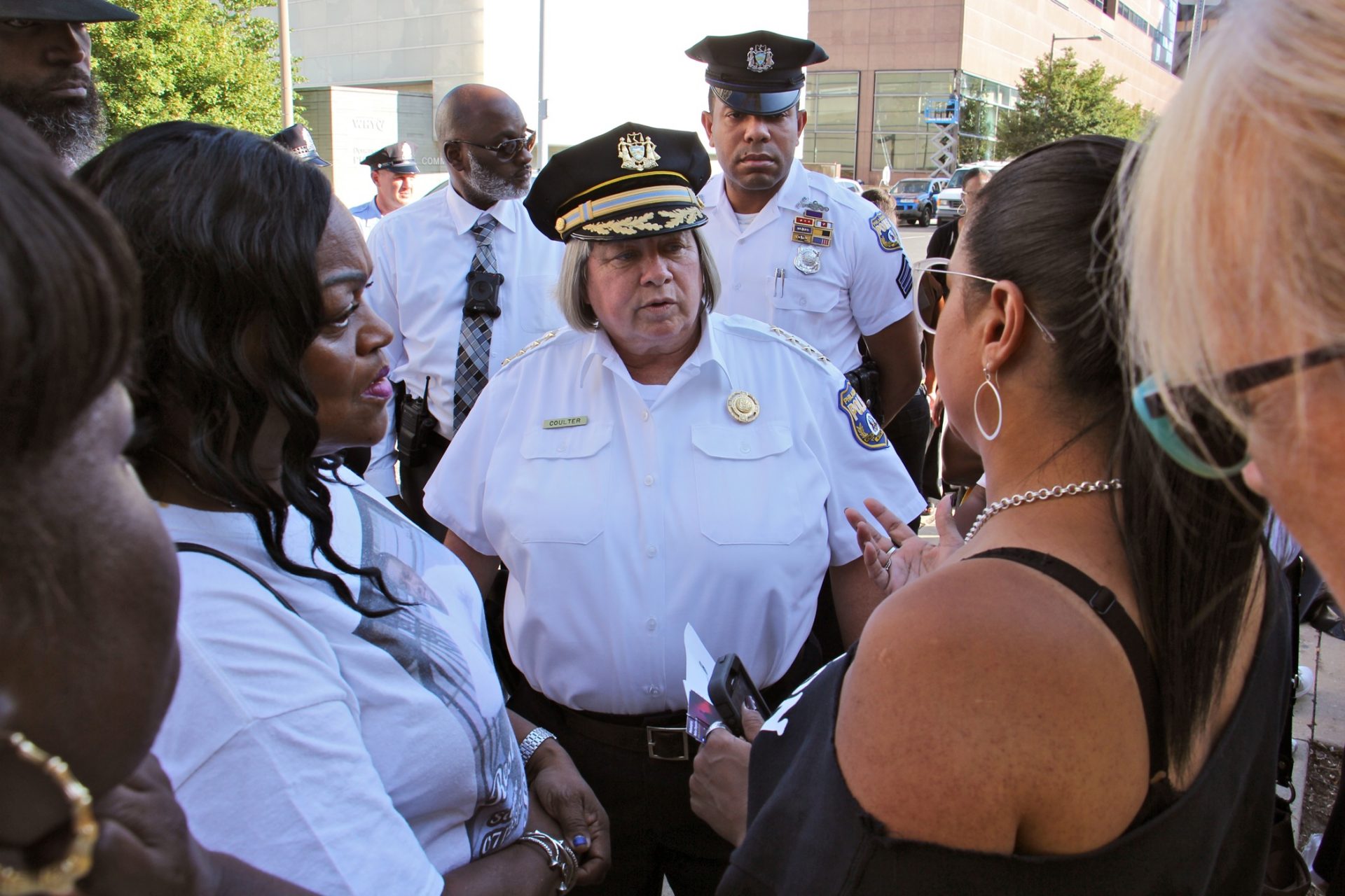 Police Commissioner Christine Coulter talks with the mothers of homicide victims during a demonstration at the police station to call attention to unsolved murders.