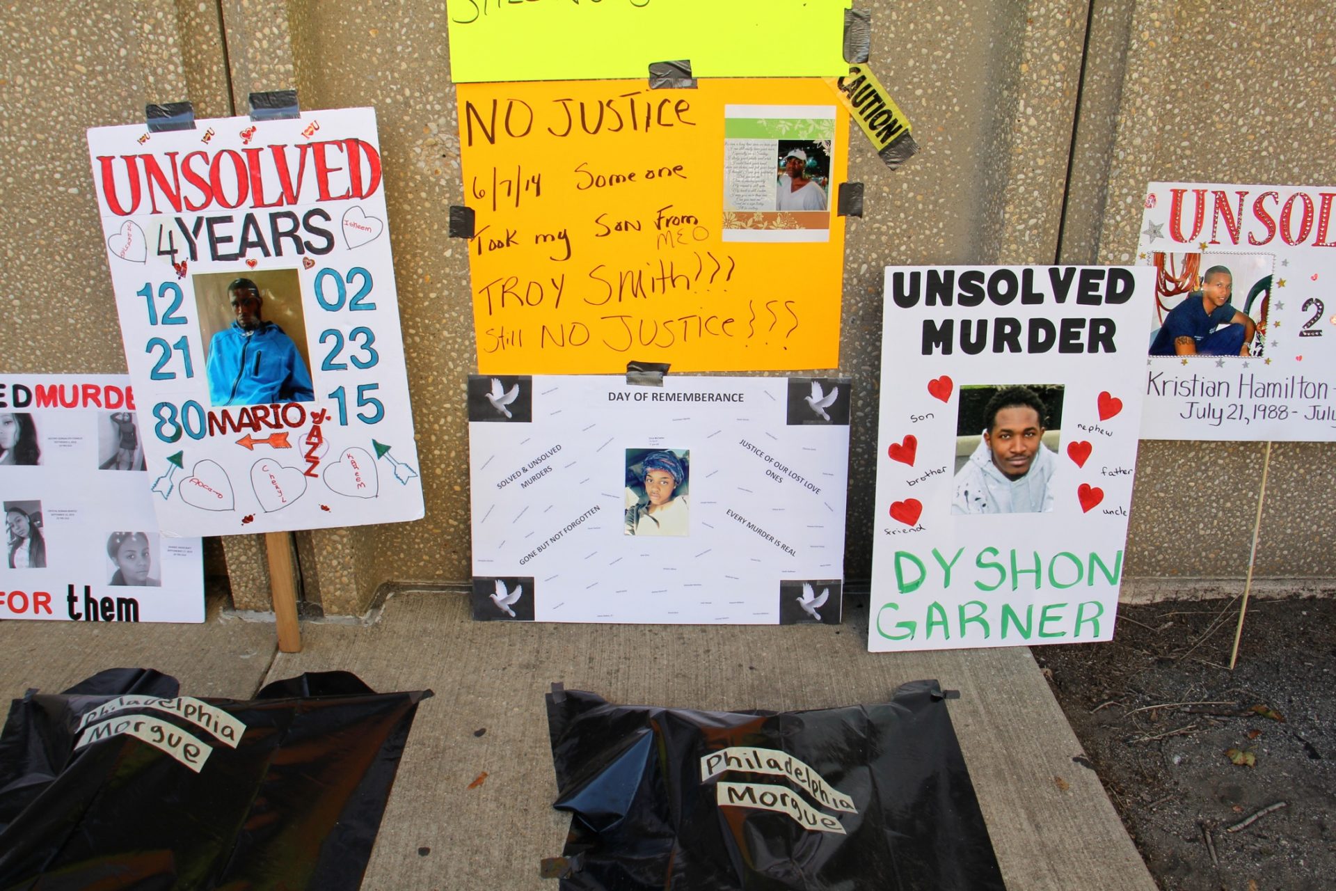 A demonstration outside the Philadelphia police station calls attention to the city's high unsolved murder rate.