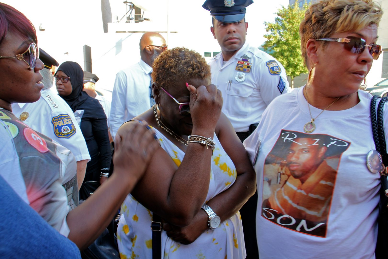 Sonya Dixon (center), whose two grandsons were murdered in 2017 and 2018, weeps during a demonstration outside the Philadelphia police station to call attention to unsolved murders.
