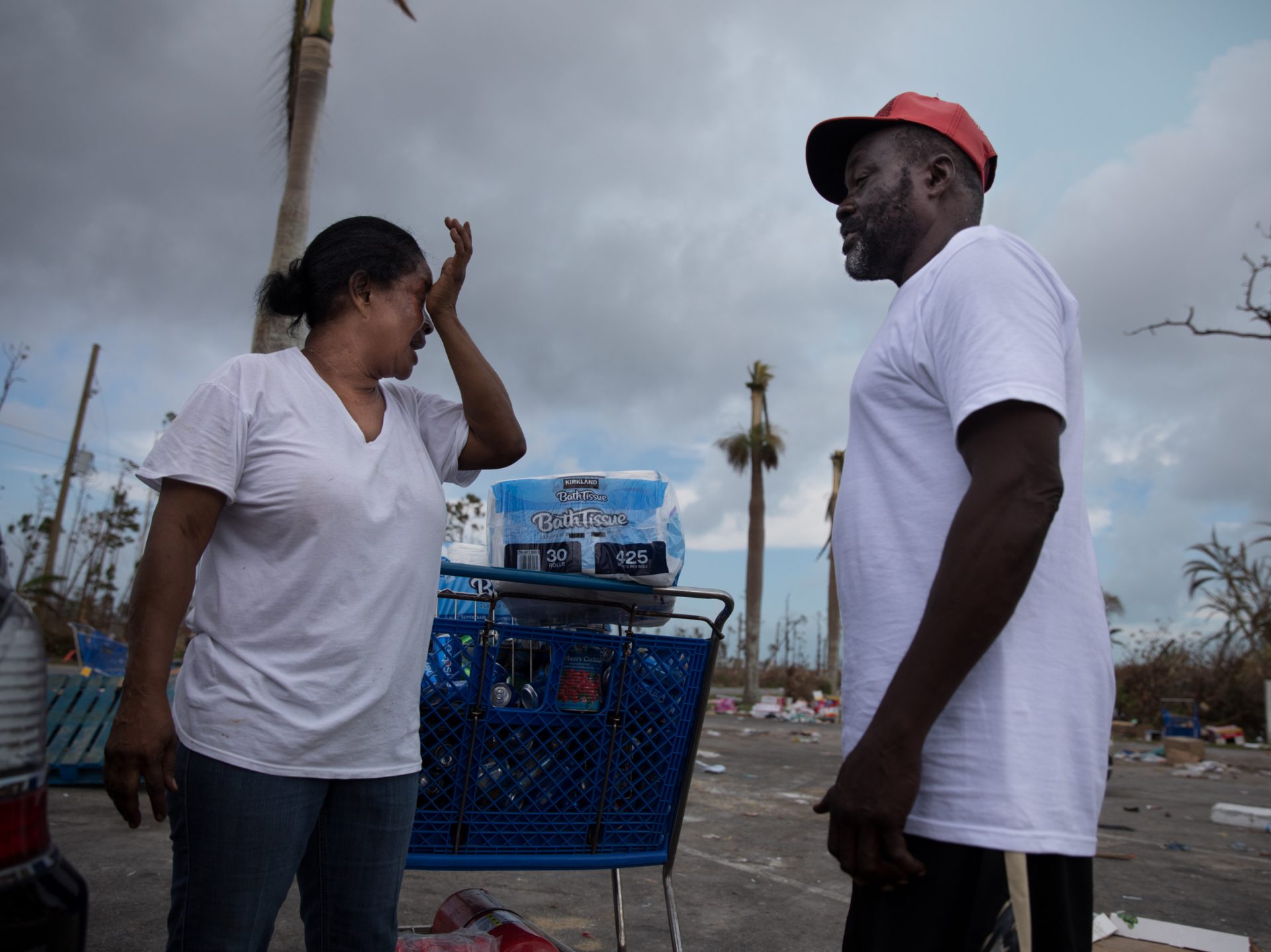 Judy Roker chats with friend John Battles Tate after stocking up on basic provisions, like water, toilet paper and canned goods from Abaco Groceries in Marsh Harbour.