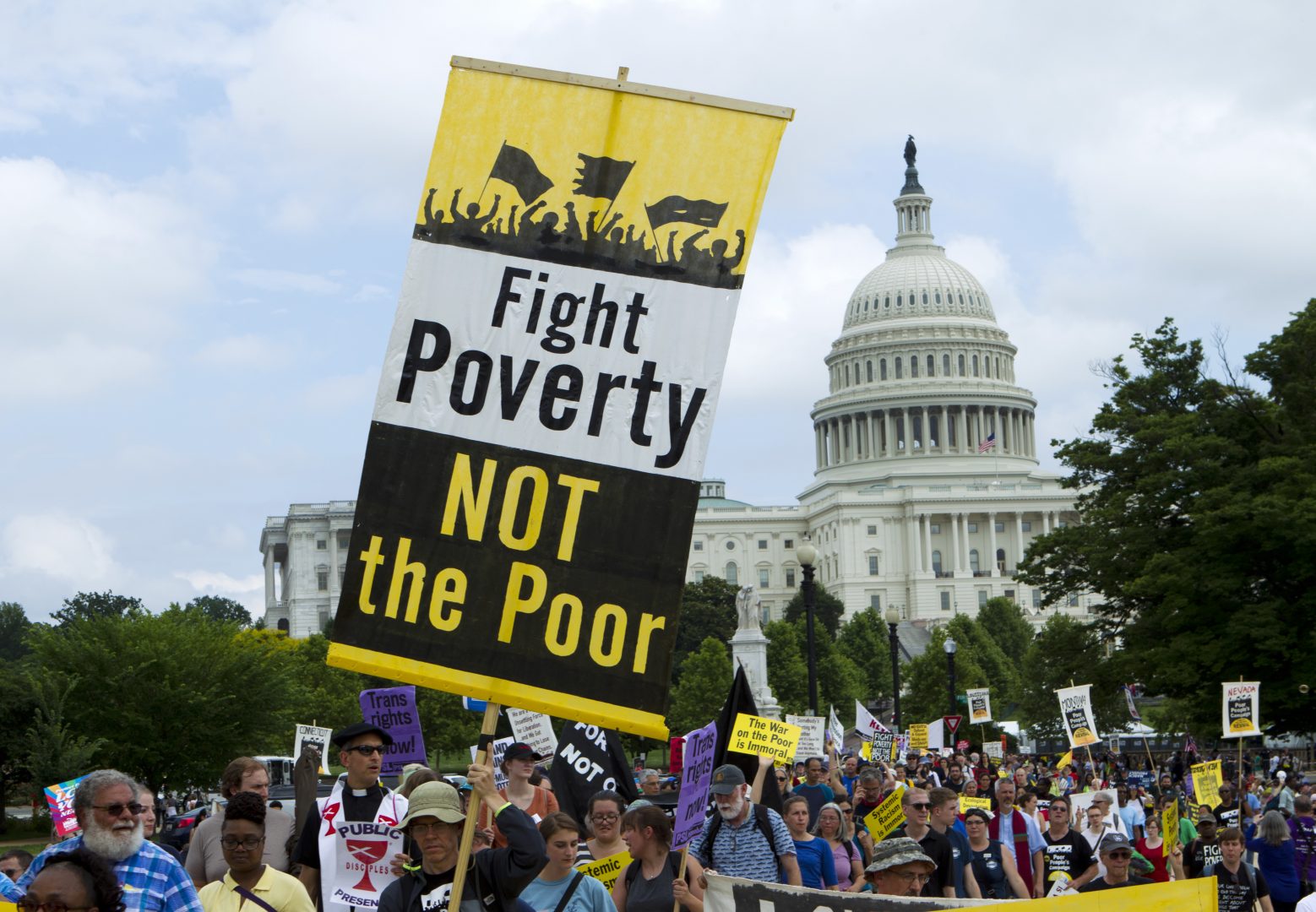 Demonstrators march outside the U.S. Capitol during the Poor People's Campaign rally at the National Mall in Washington on Saturday, June 23, 2018.