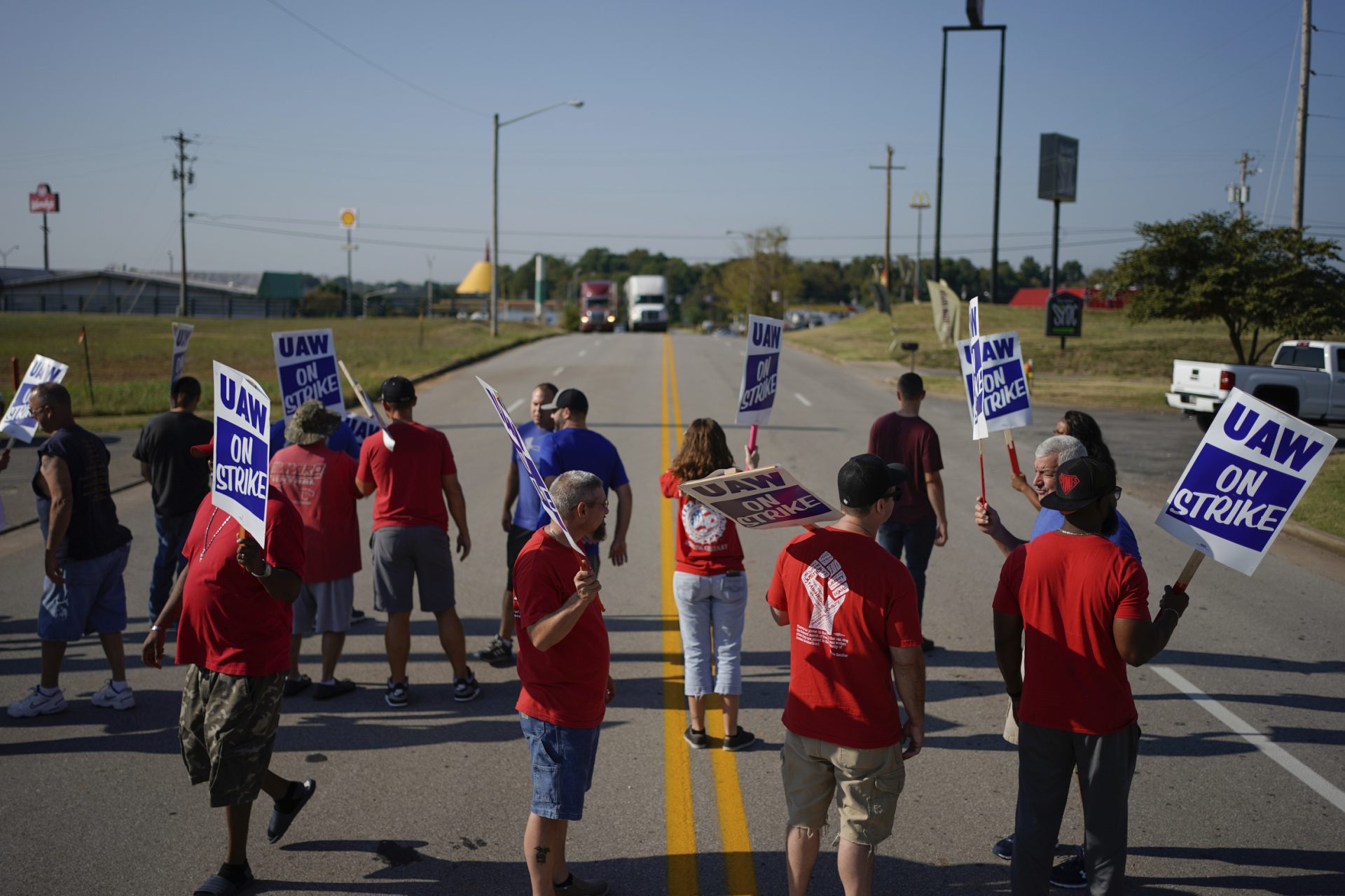 Striking plant workers block the passage of two trucks outside the General Motor assembly plant in Bowling Green, Ky, Monday, Sept. 16, 2019. More than 49,000 members of the United Auto Workers walked off General Motors factory floors or set up picket lines early Monday as contract talks with the company deteriorated into a strike.