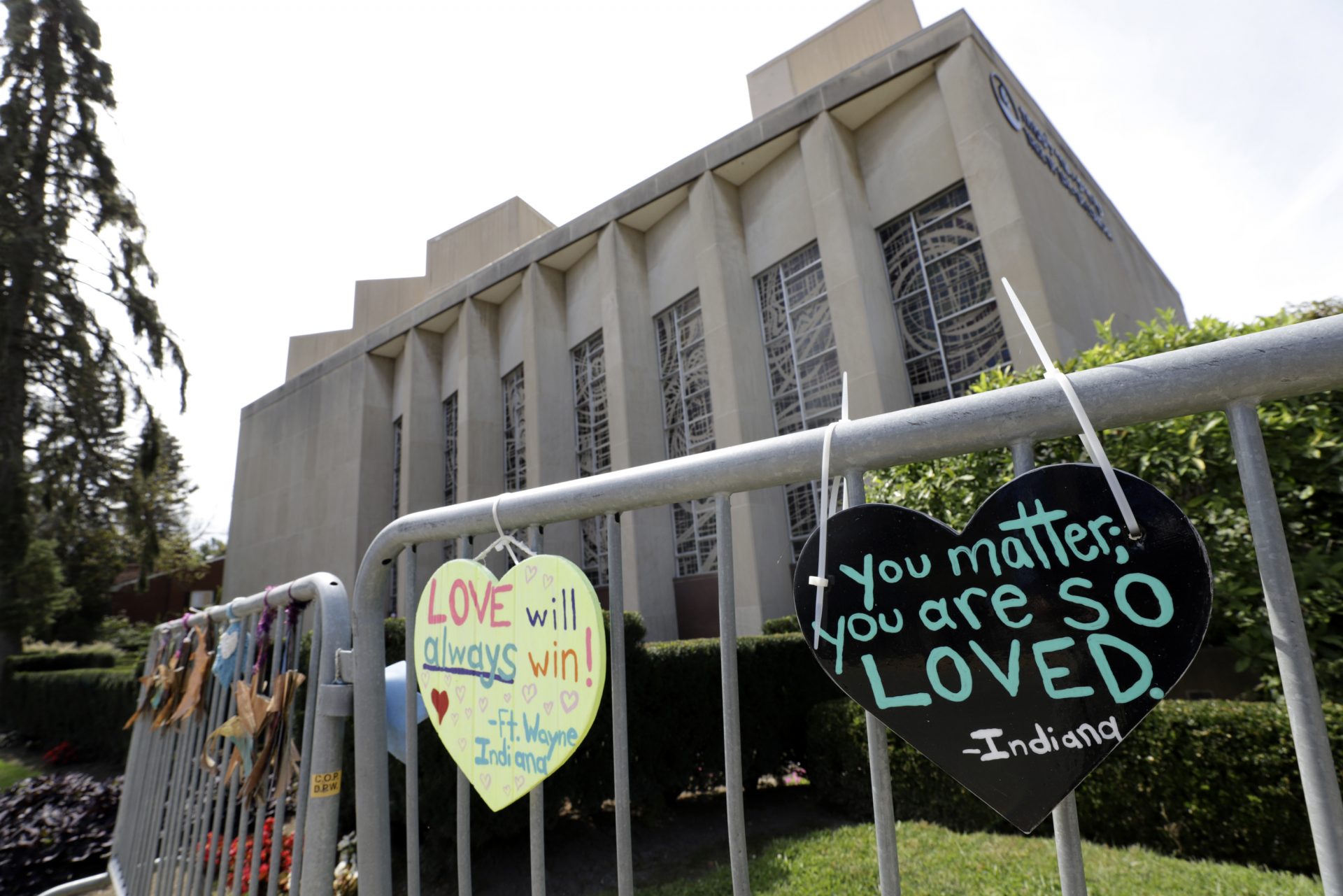 Signs hang on a fence surrounding the Tree of Life synagogue in Pittsburgh on Tuesday, Sept. 17, 2019. The first anniversary of the shooting at the synagogue, that killed 11 worshippers, is Oct., 27, 2019. Authorities charged Robert Bowers, 47, a truck driver from Baldwin, Pennsylvania, in the attack that killed eight men and three women, and wounded seven others inside Tree of Life synagogue, where congregants from New Light and Dor Hadash also had gathered. Bowers has pleaded not guilty . He faces the death penalty if convicted.