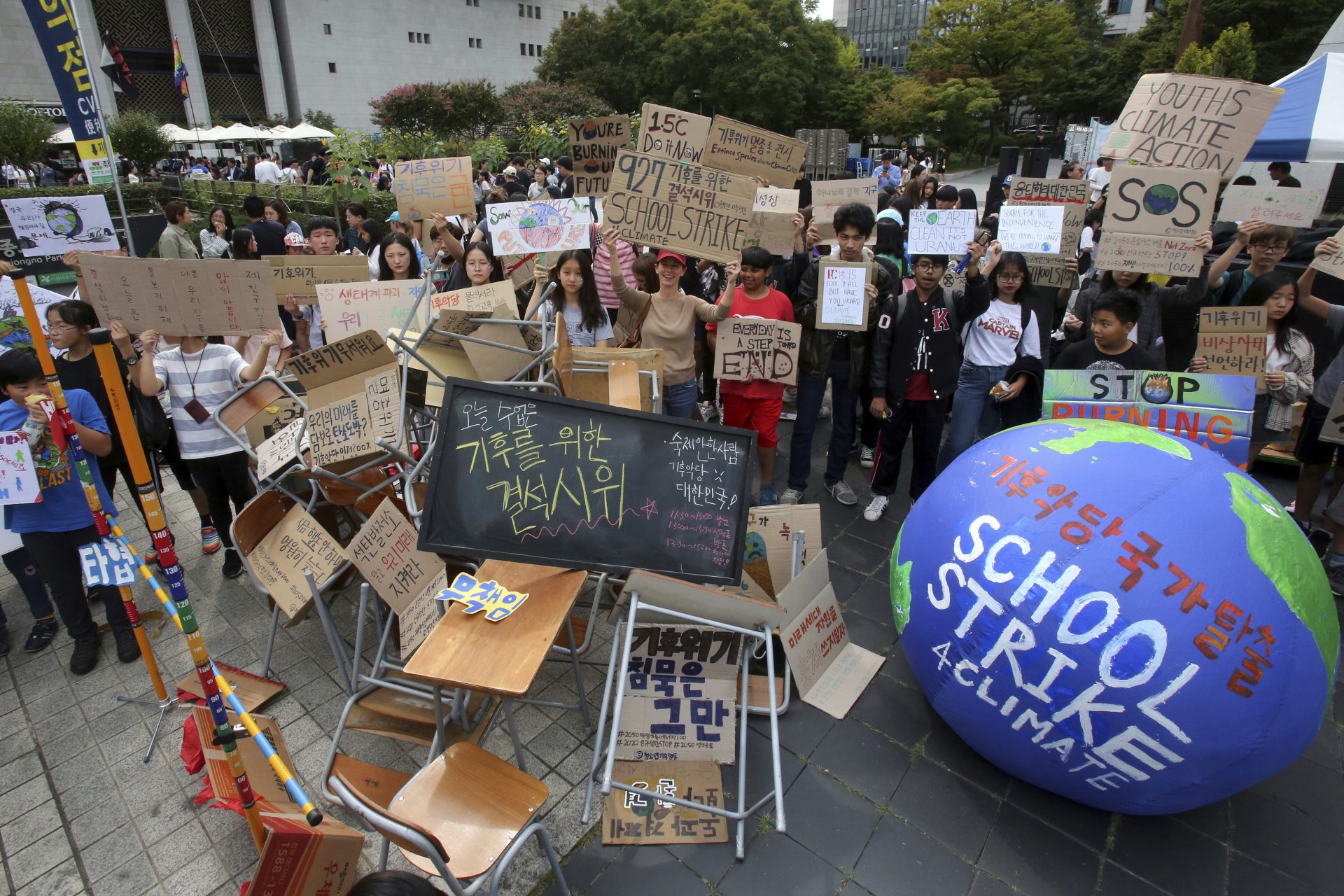 Students stage a rally demanding the escape from the climate crisis in Seoul, South Korea, Friday, Sept. 27, 2019. Hundreds of students boycotted classes and gathered to demand world leaders' action to stop climate change.