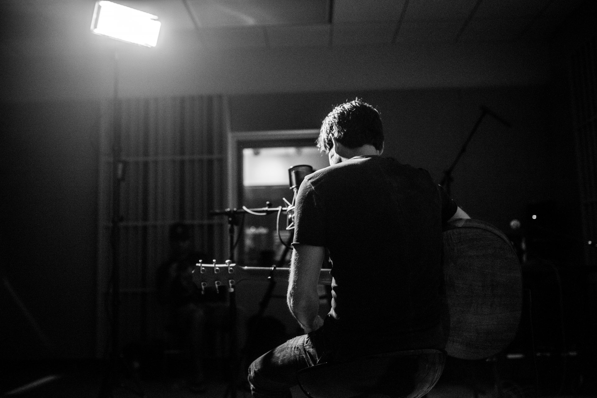 Ben Gallaher playing guitar and singing.