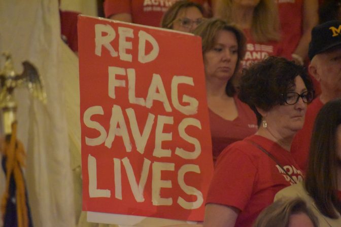 A demonstrator with the Pennsylvania chapter of Moms Demand Action holds a sign that reads "Red Flag Saves Lives" during a rally on Sept. 17, 2019, in the Pennsylvania state Capitol in Harrisburg.