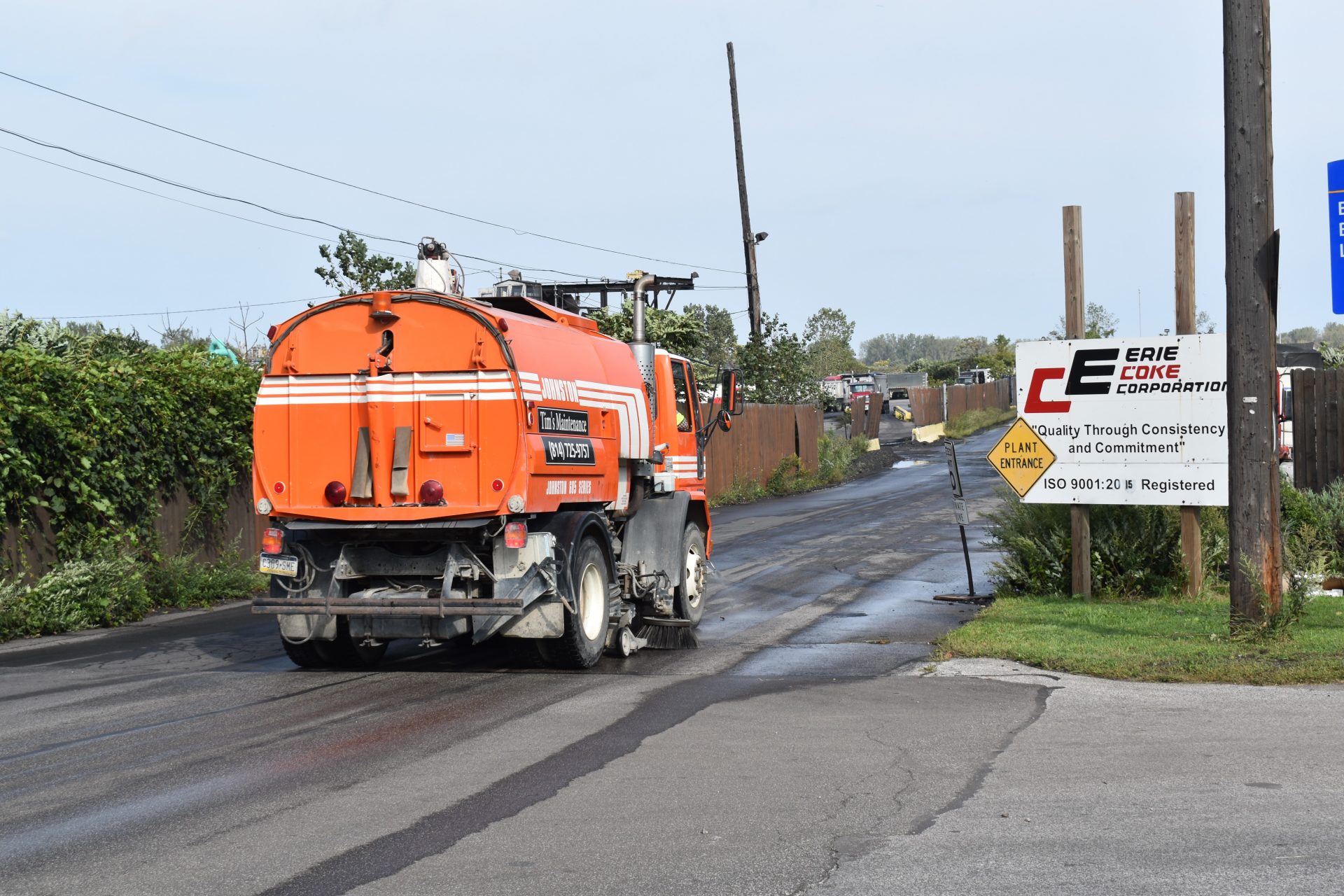 A vehicle cleans the road leading into Erie Coke on Sept. 13, 2019.