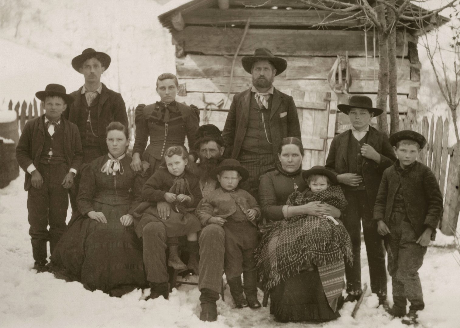 William Anderson Hatfield (center) sits surrounded by his family on a winter's day. Circa 1890s.