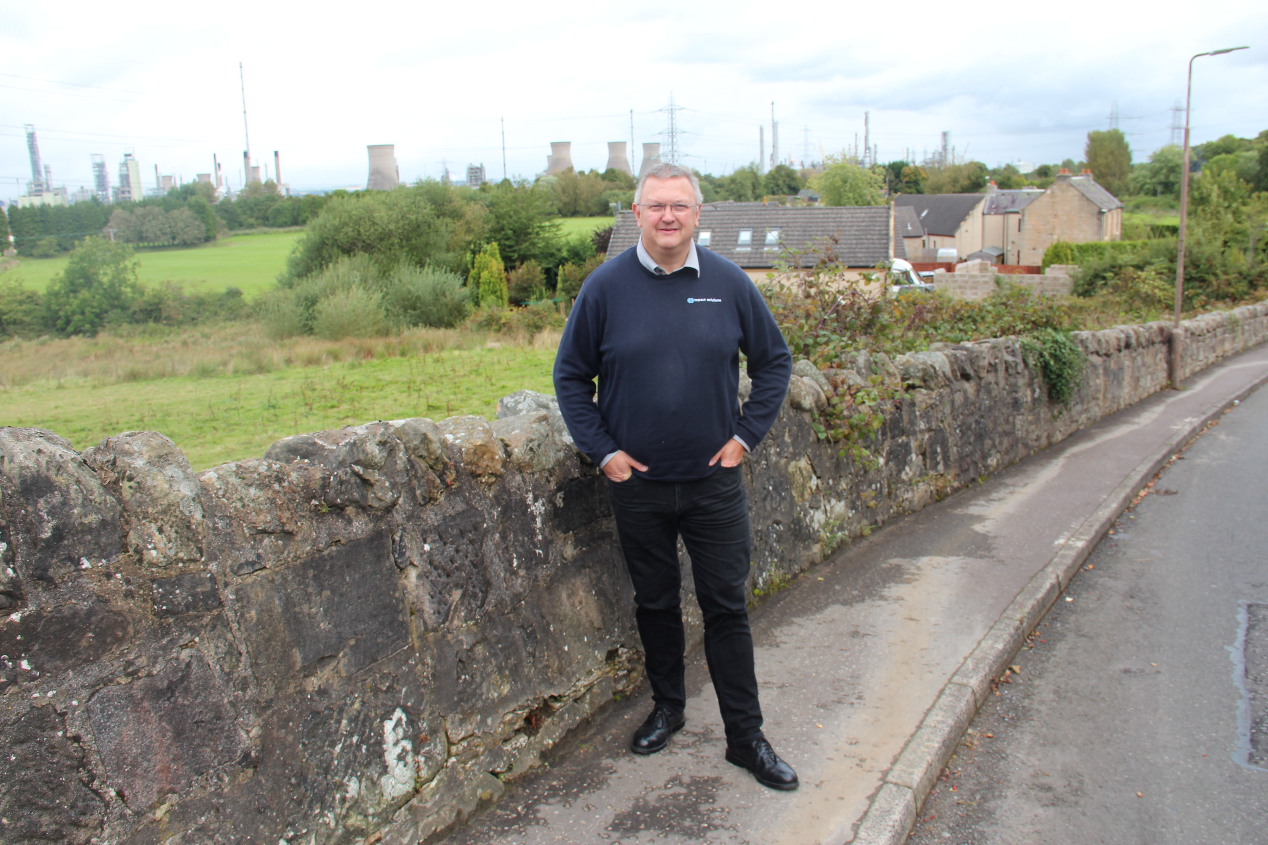 Kevin Ross, president of the Scottish Plastic and Rubber Association, in front of the INEOS Grangemouth refinery and chemical plant.