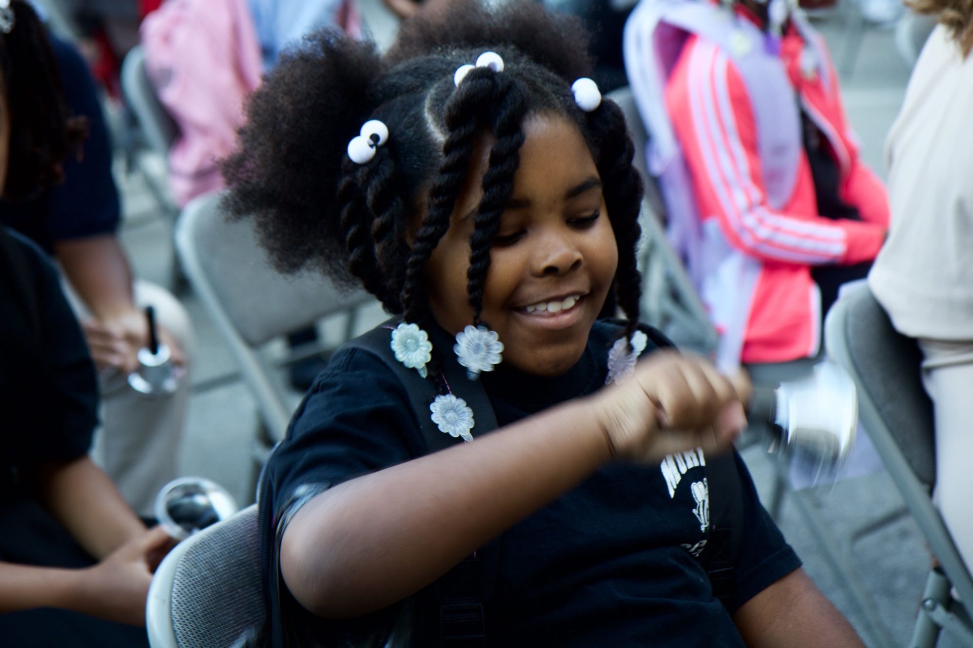 2nd grader Navayah Reynolds rings in the new school year at the 2019 start of school bell ringing ceremony in Philadelphia. 