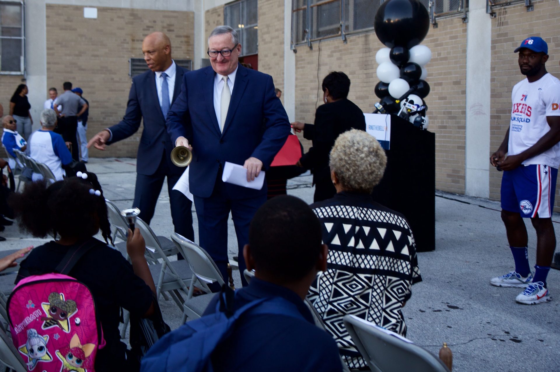 Philadelphia superintendent William Hite and Mayor Jim Kenney ring bells with students at Robert Morris Elementary School.