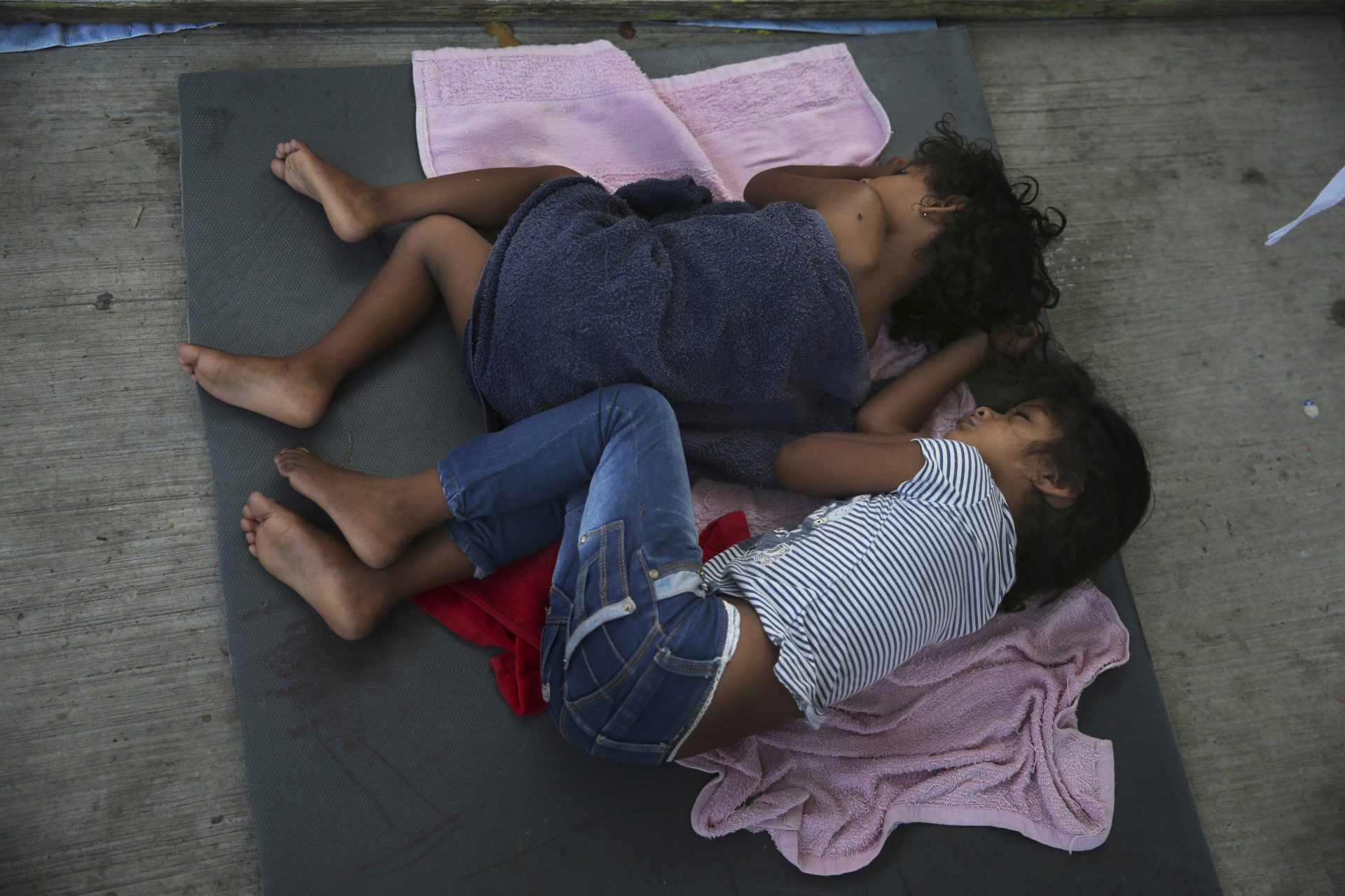 FILE PHOTO: In this July 17, 2019 file photo, migrant children sleep on a mattress on the floor of the AMAR migrant shelter in Nuevo Laredo, Mexico.