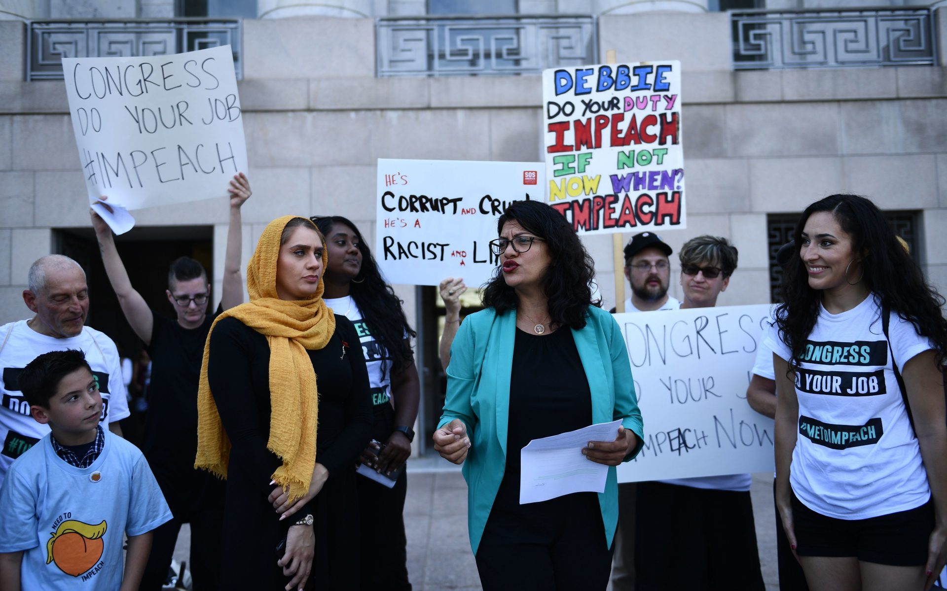 Rep. Rashida Tlaib, D-Mich., joins activists asking for impeachment of President Trump on Capitol Hill on Monday.