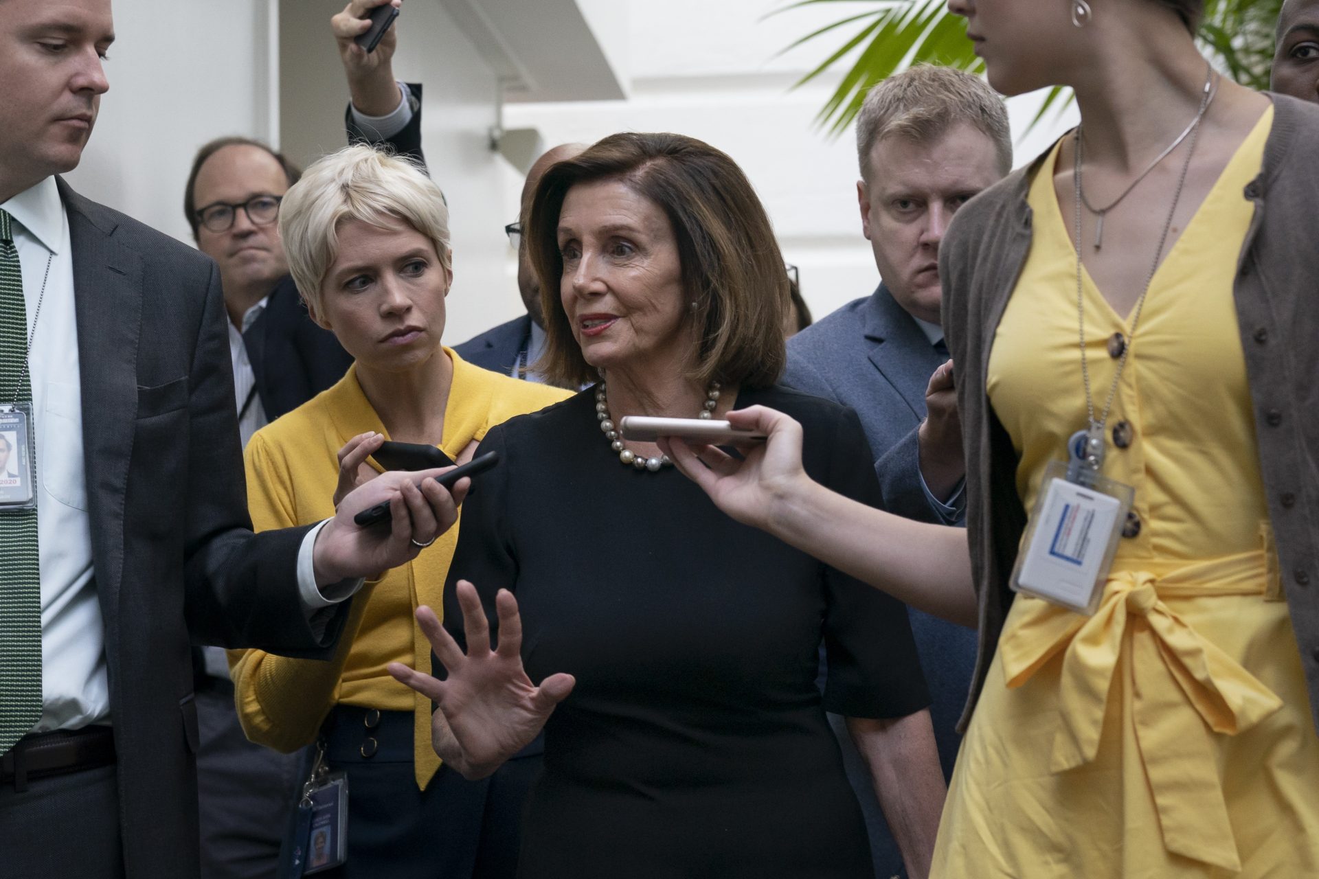 Speaker of the House Nancy Pelosi, D-Calif., is surrounded by reporters as she arrives to meet with her caucus the morning after declaring she will launch a formal impeachment inquiry against President Donald Trump, at the Capitol in Washington, Wednesday, Sept. 25, 2019