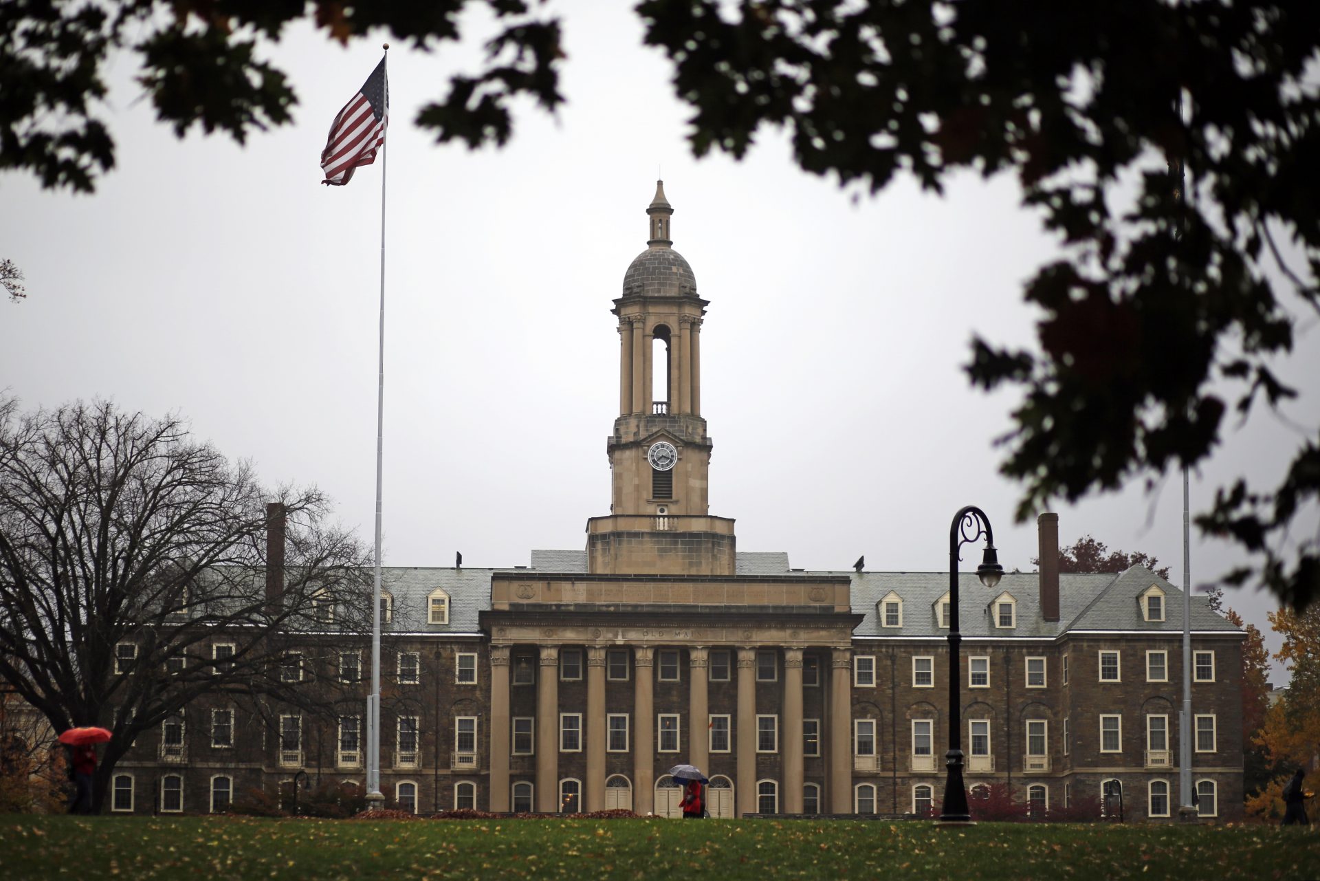 FILE PHOTO: A Penn State student walks in the rain past Old Main on the Penn State main campus in State College, Pa., Wednesday, Oct. 28, 2015.